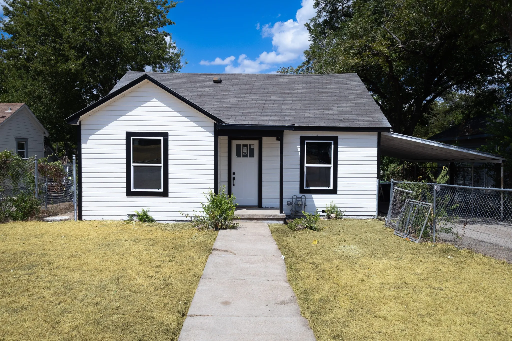White siding exterior with black trim accents