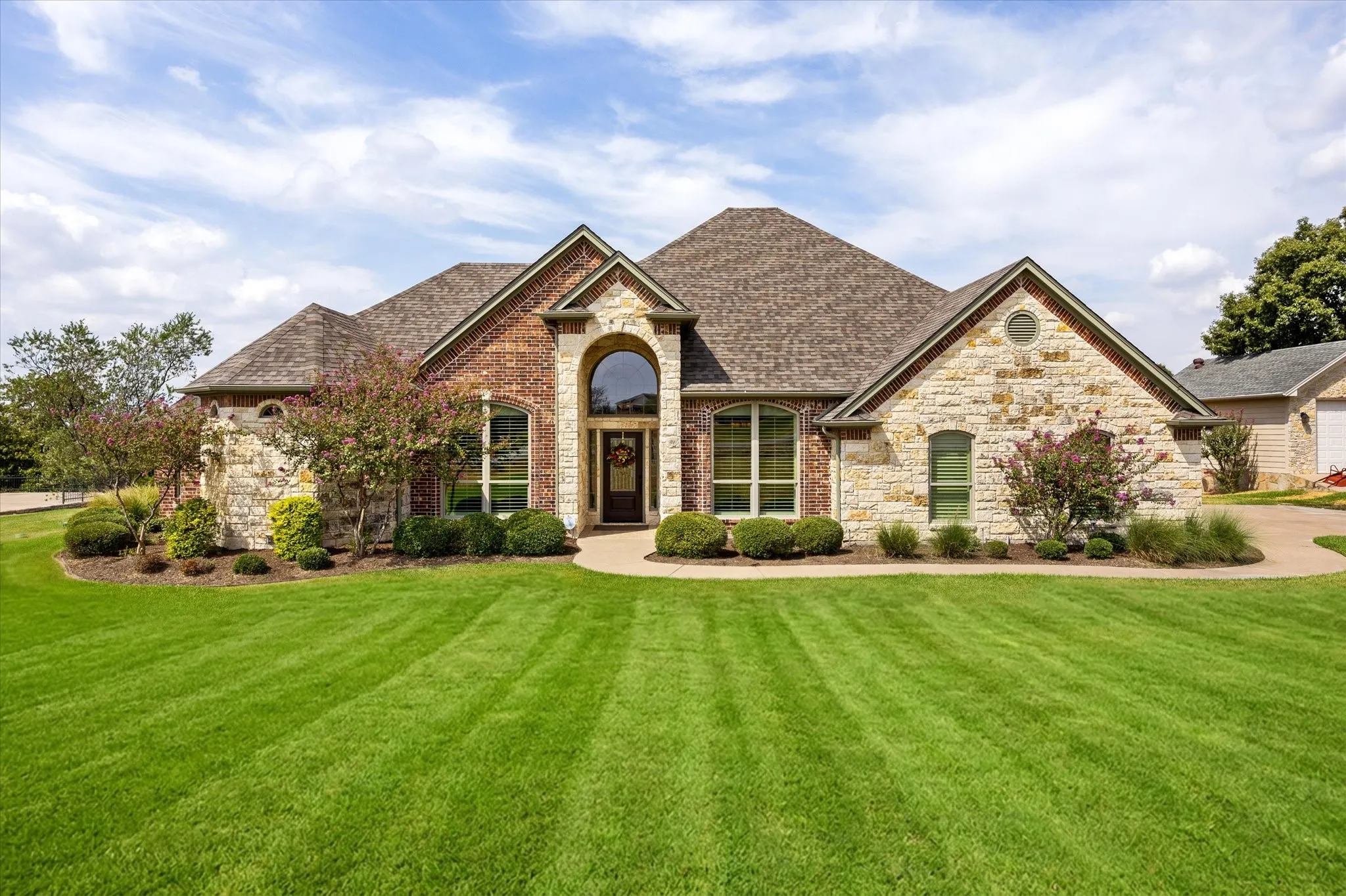 Striking rock and stone architecture creates a welcoming and impressive drive-up.