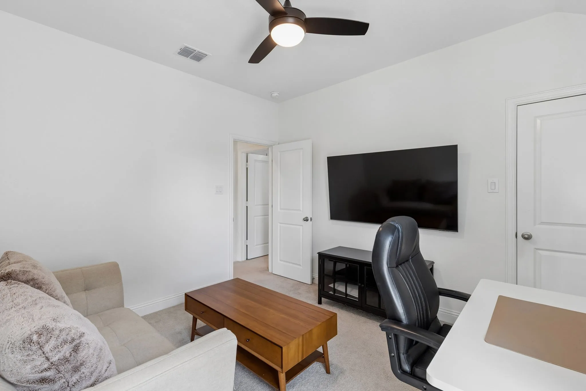 Another view of the versatile bedroom that provides space for both work and relaxation.