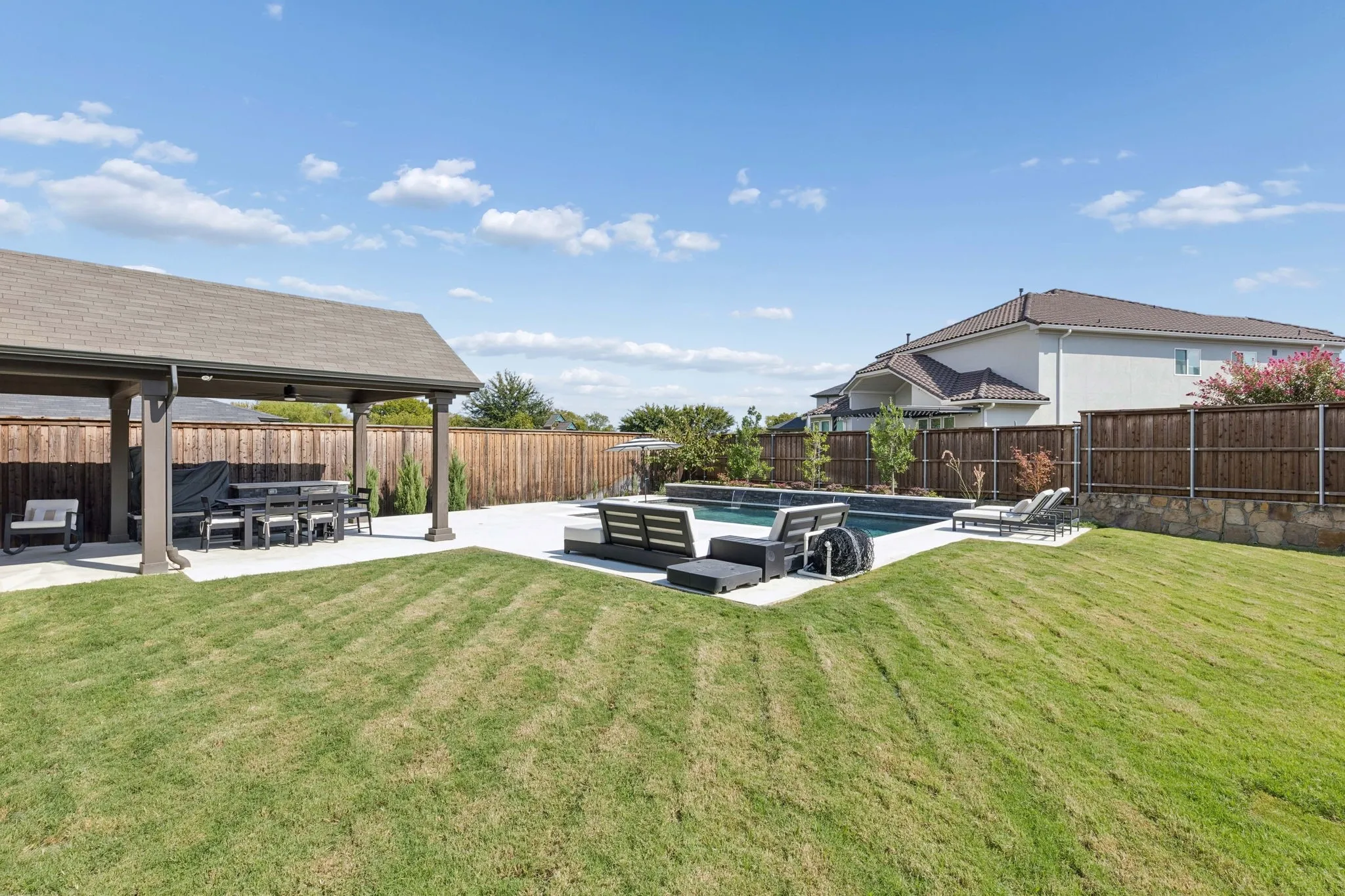 Expansive backyard offers plenty of room to relax and play, with a sparkling pool and spa, generous sun deck, manicured lawn, privacy fencing, and thoughtfully landscaped perimeter.