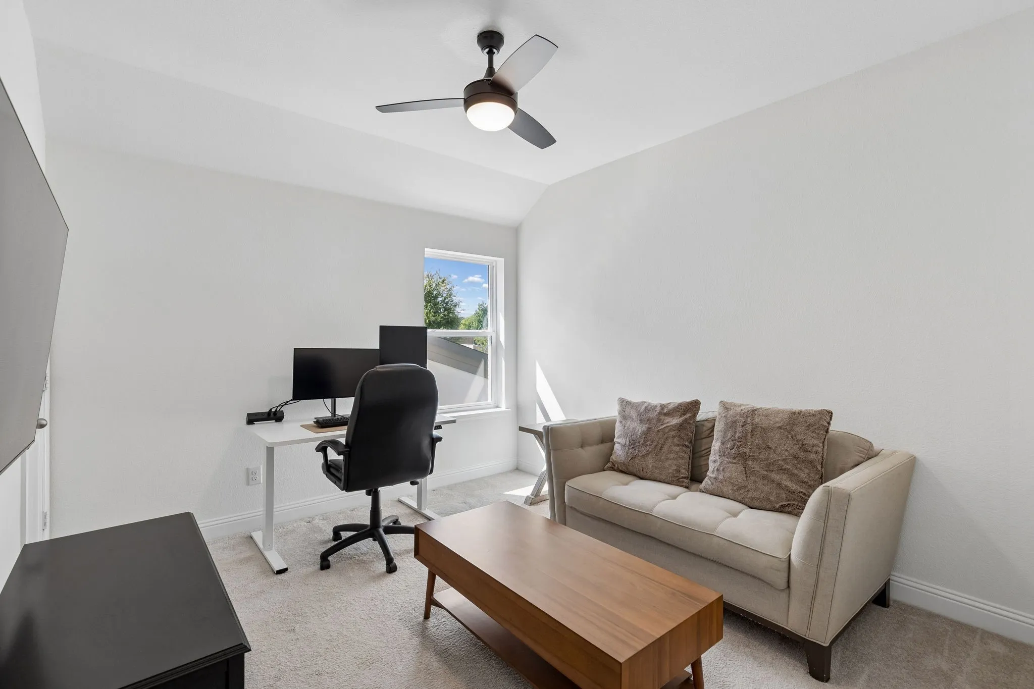 Flexible upstairs bedroom that combines a dedicated home office with a cozy sitting area, offering an ideal work-from-home environment with plenty of natural light and room to unwind.