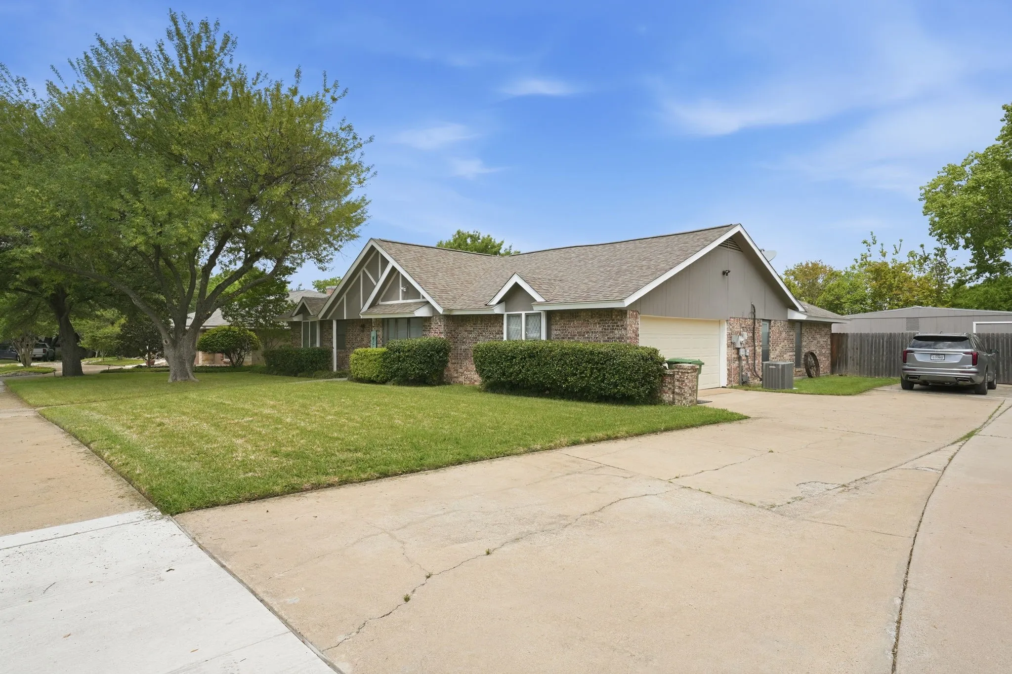 Brick exterior with a gabled roof and attached garage