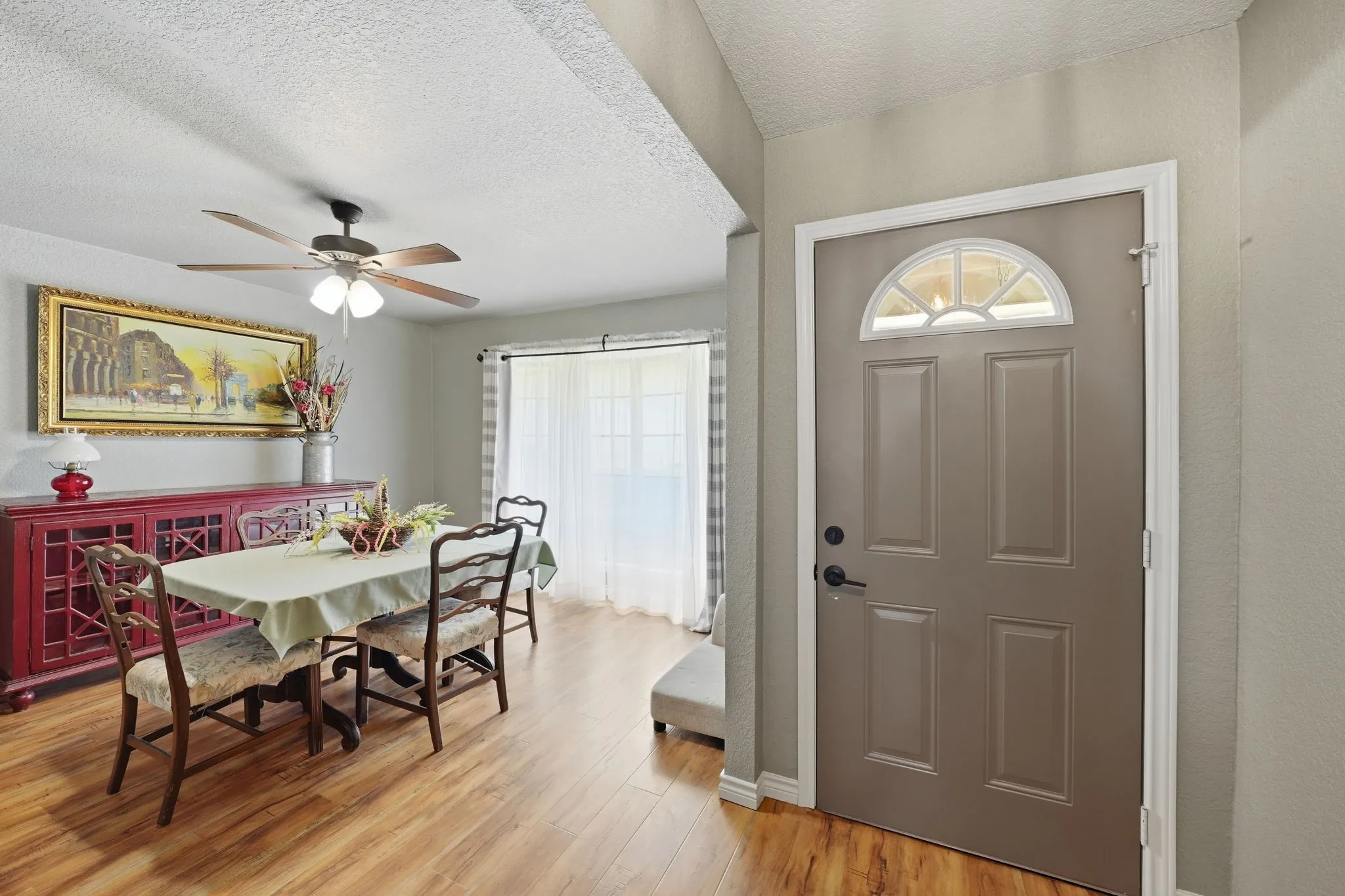 Entry door with arched transom window and formal dining