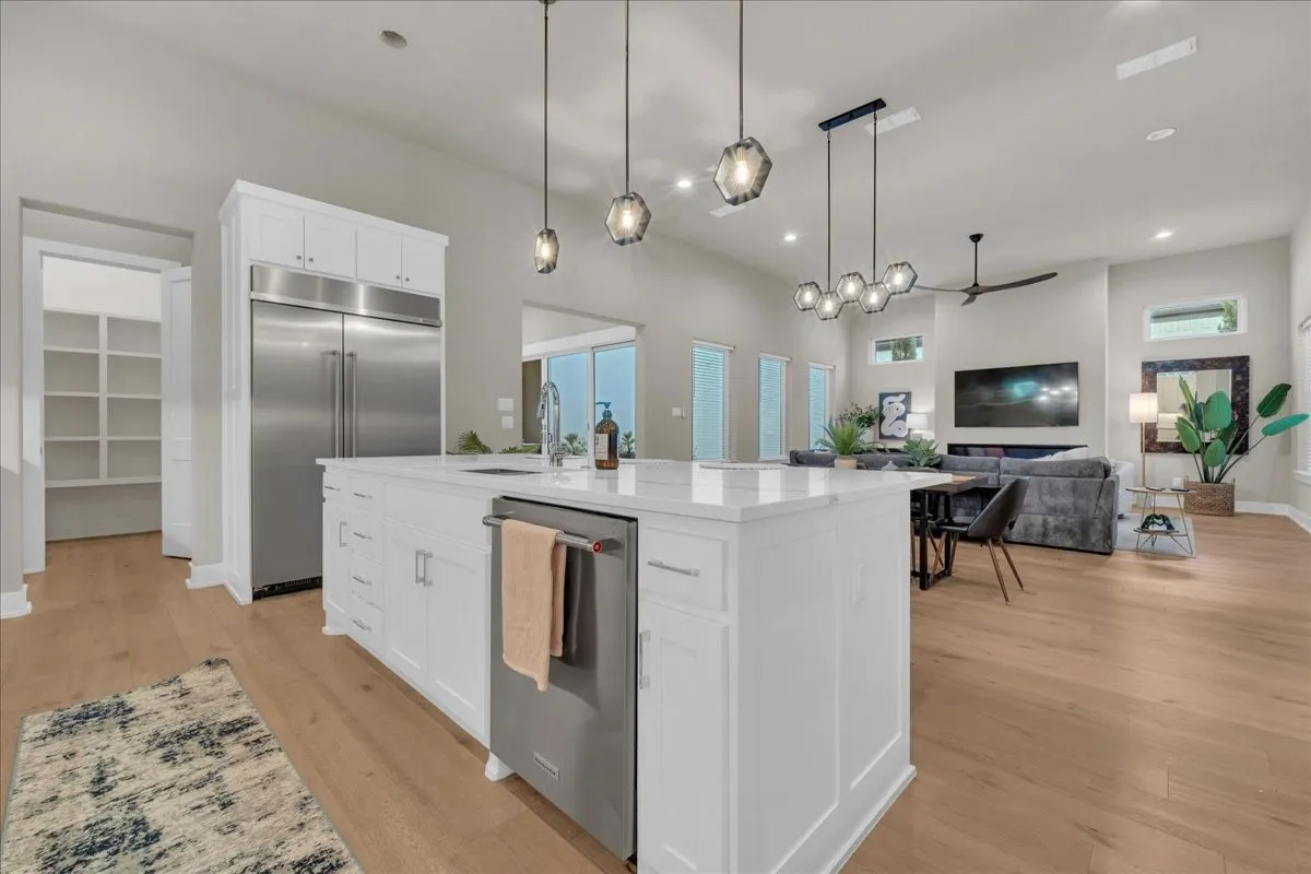 Modern kitchen Quartz island with white cabinetry and a built-in KitchenAid appliances