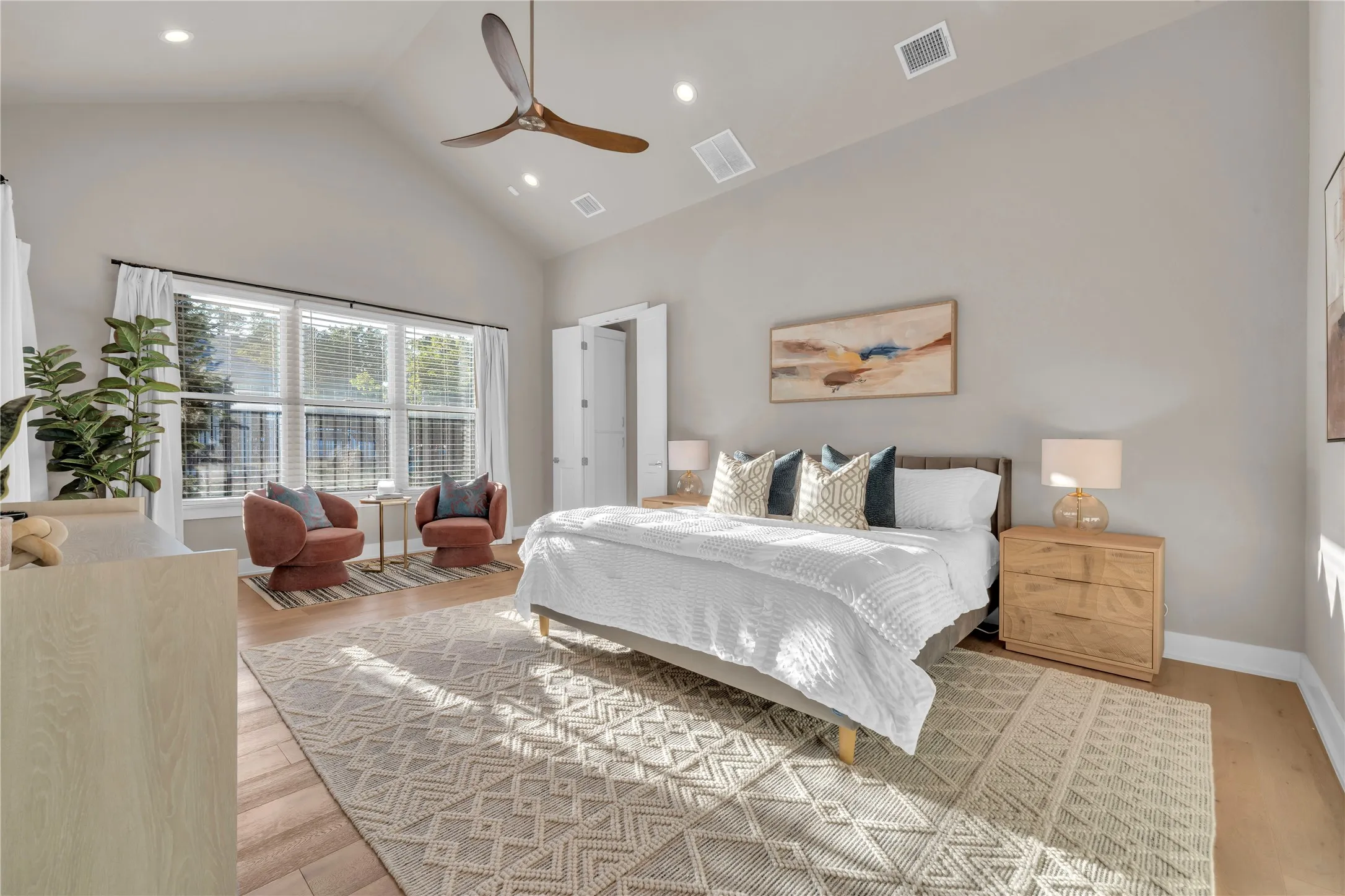 Vaulted ceiling with a wood-finish ceiling fan, recessed lighting, expansive windows, and wood flooring