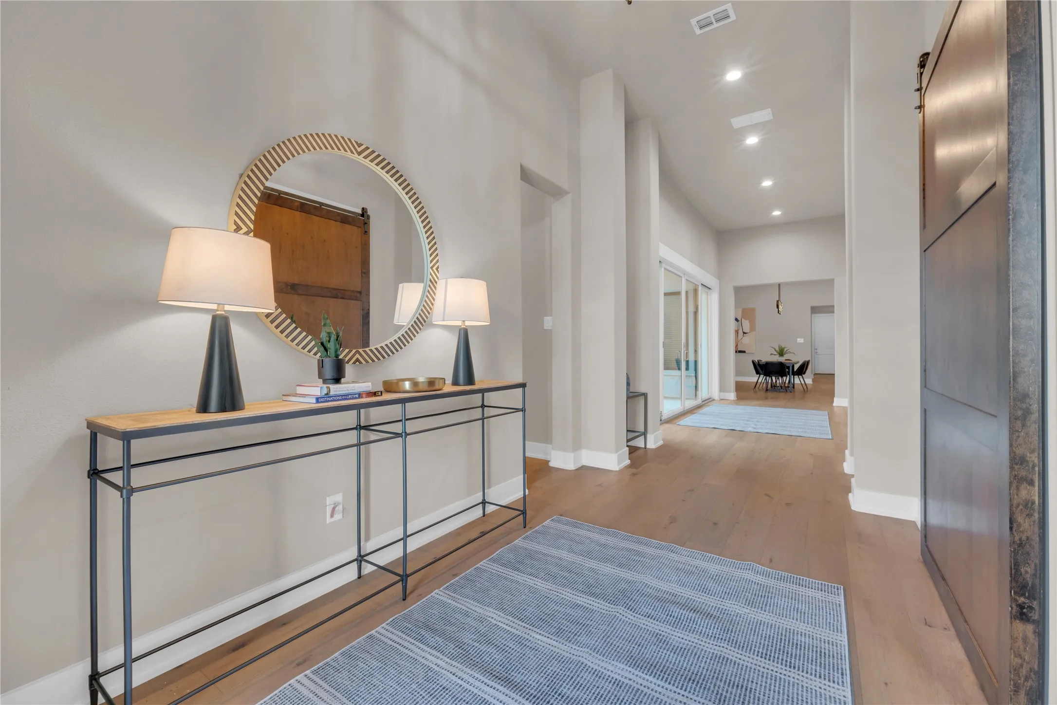Upon entering the front door 7.5 Wood flooring, recessed lighting, and a 12' high ceiling