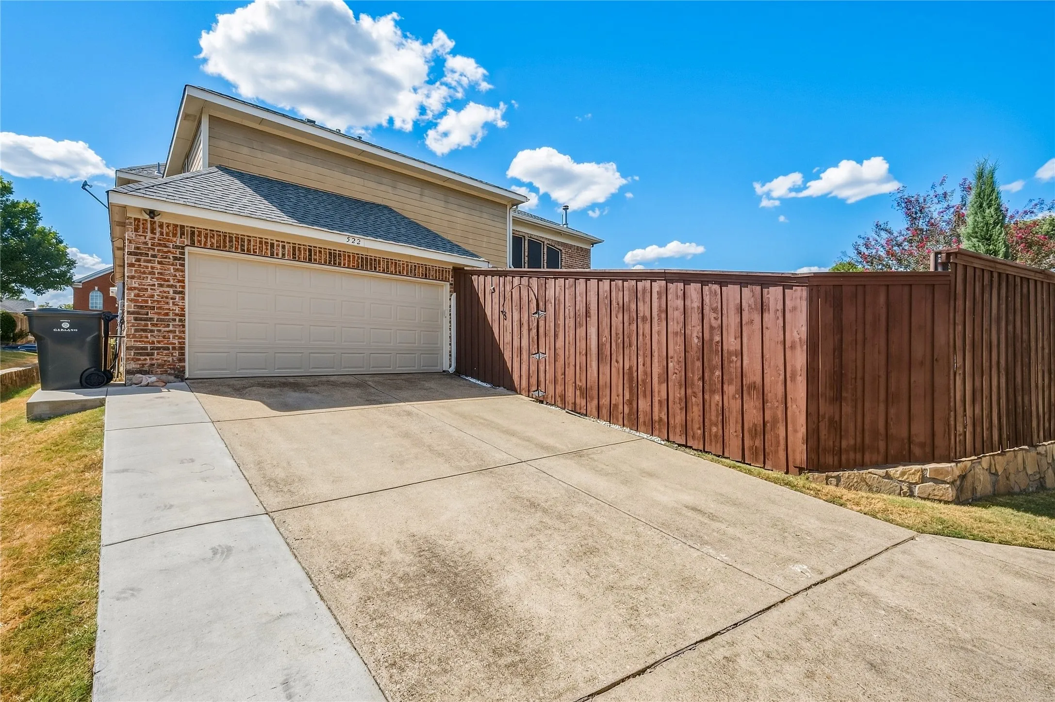 Brick and siding exterior with an attached garage