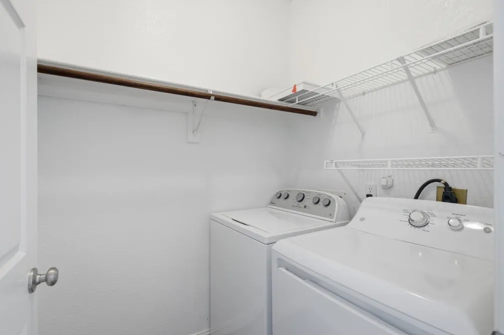 Laundry area with overhead hanging rod and wire shelving