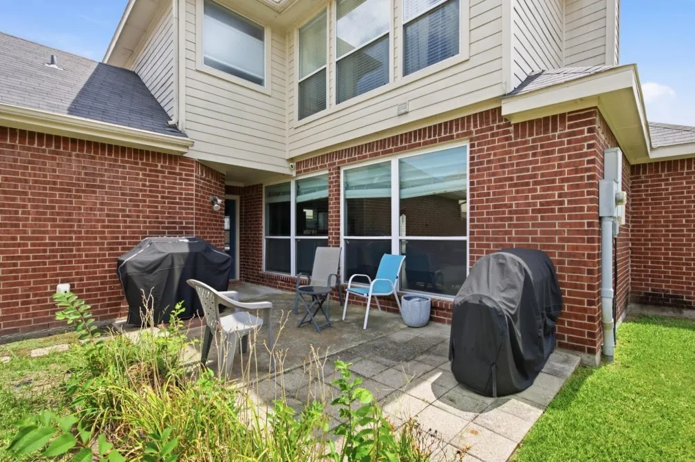 Red brick exterior with light-colored siding accents