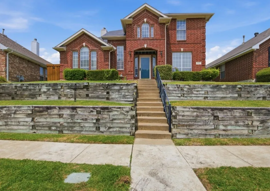 Traditional brick exterior featuring arched and rectangular windows