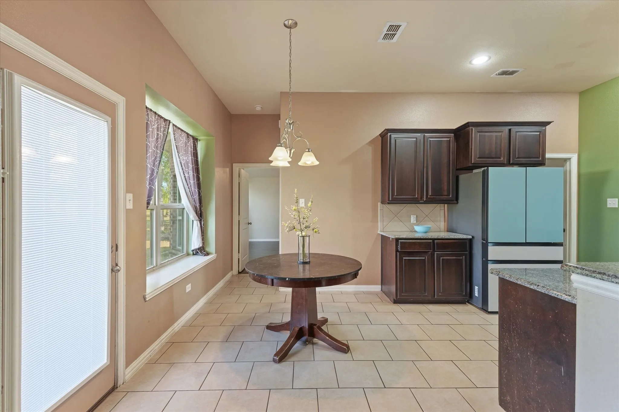 Tile flooring throughout with a large window and built-in window seat