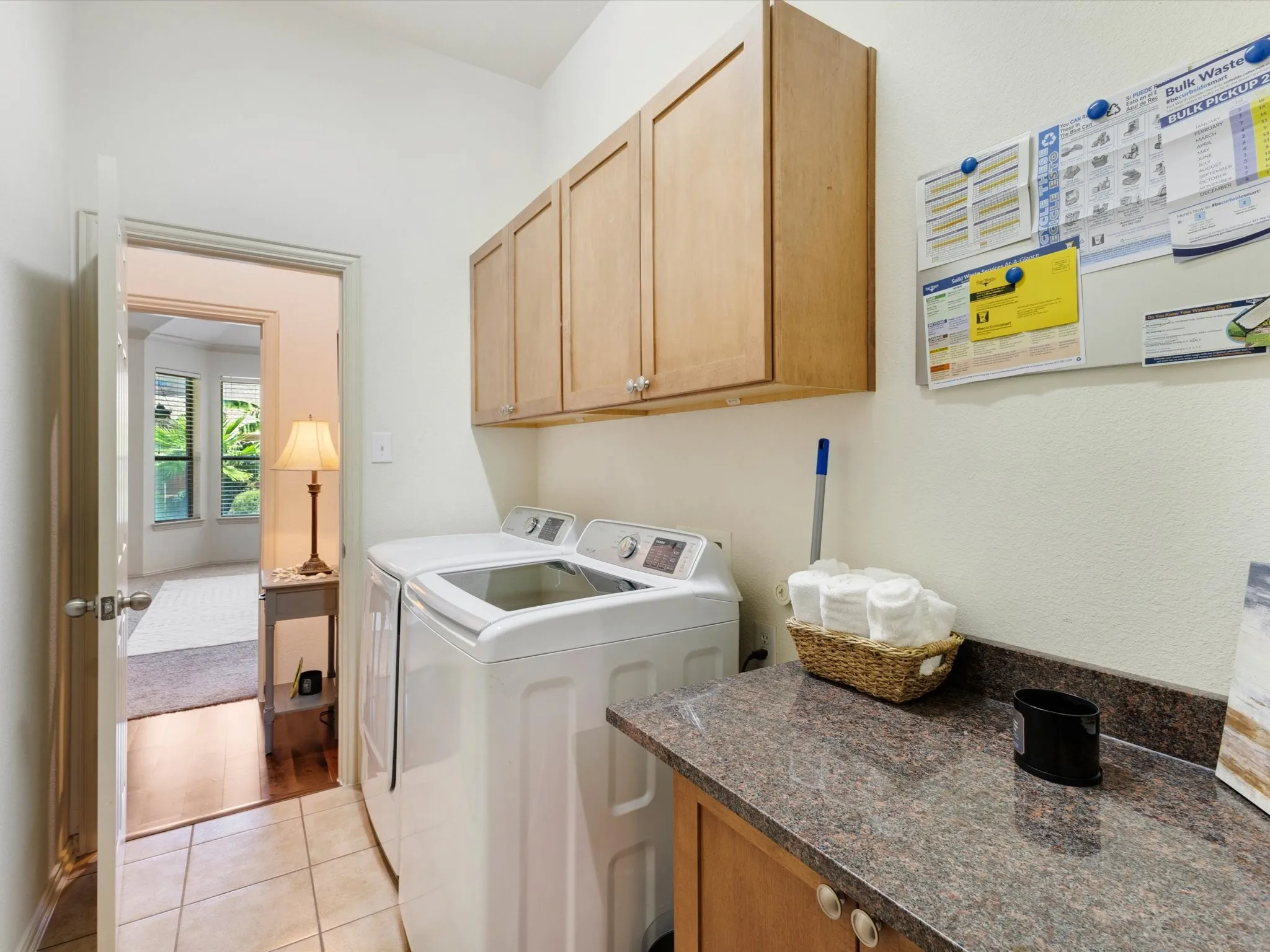 Laundry area featuring upper cabinetry, a utility sink, and a speckled countertop