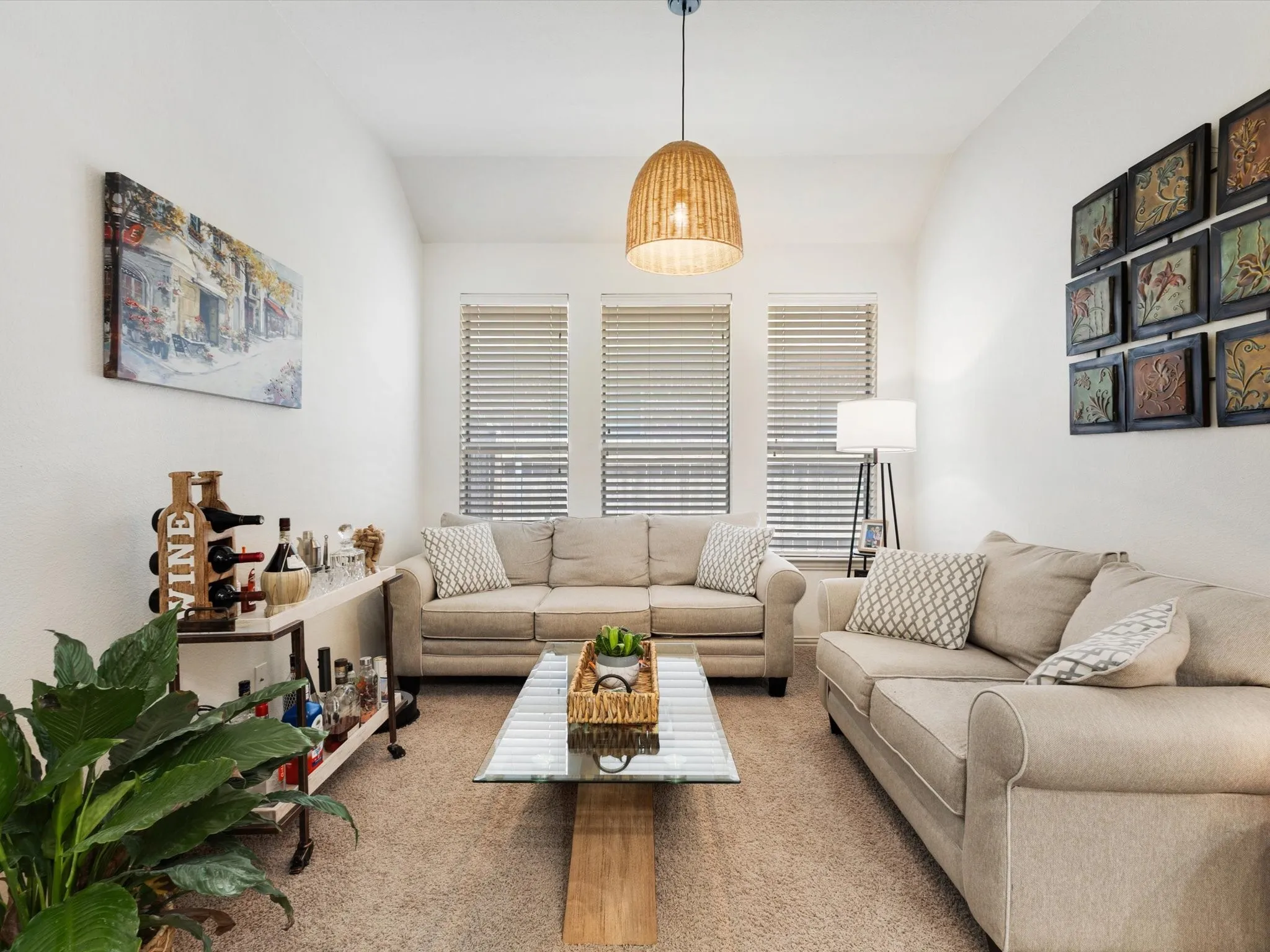 Recessed ceiling with an integrated pendant light, neutral-toned carpeting, and multiple windows with blinds