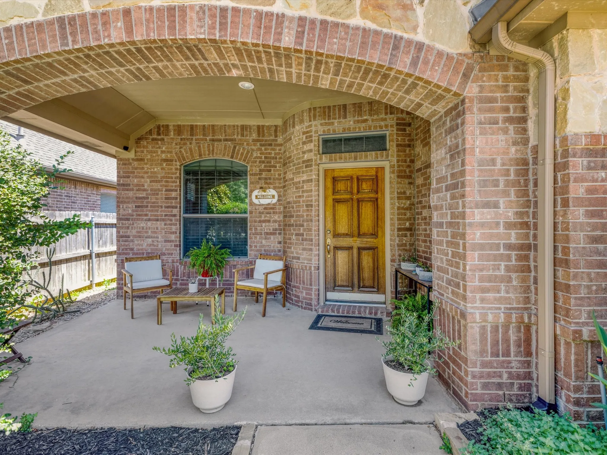 Brick and stone facade with an arched entry