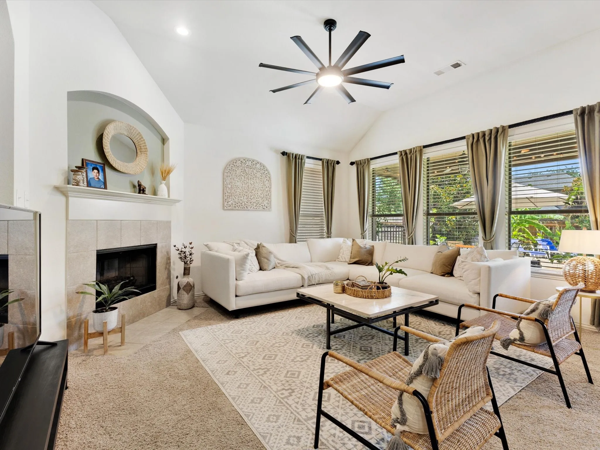 Vaulted ceiling featuring a contemporary ceiling fan