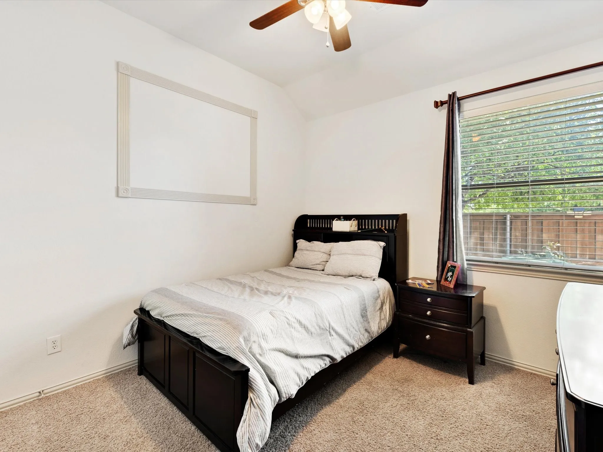 Carpeted flooring, ceiling fan with light fixture, window with blinds, and white walls