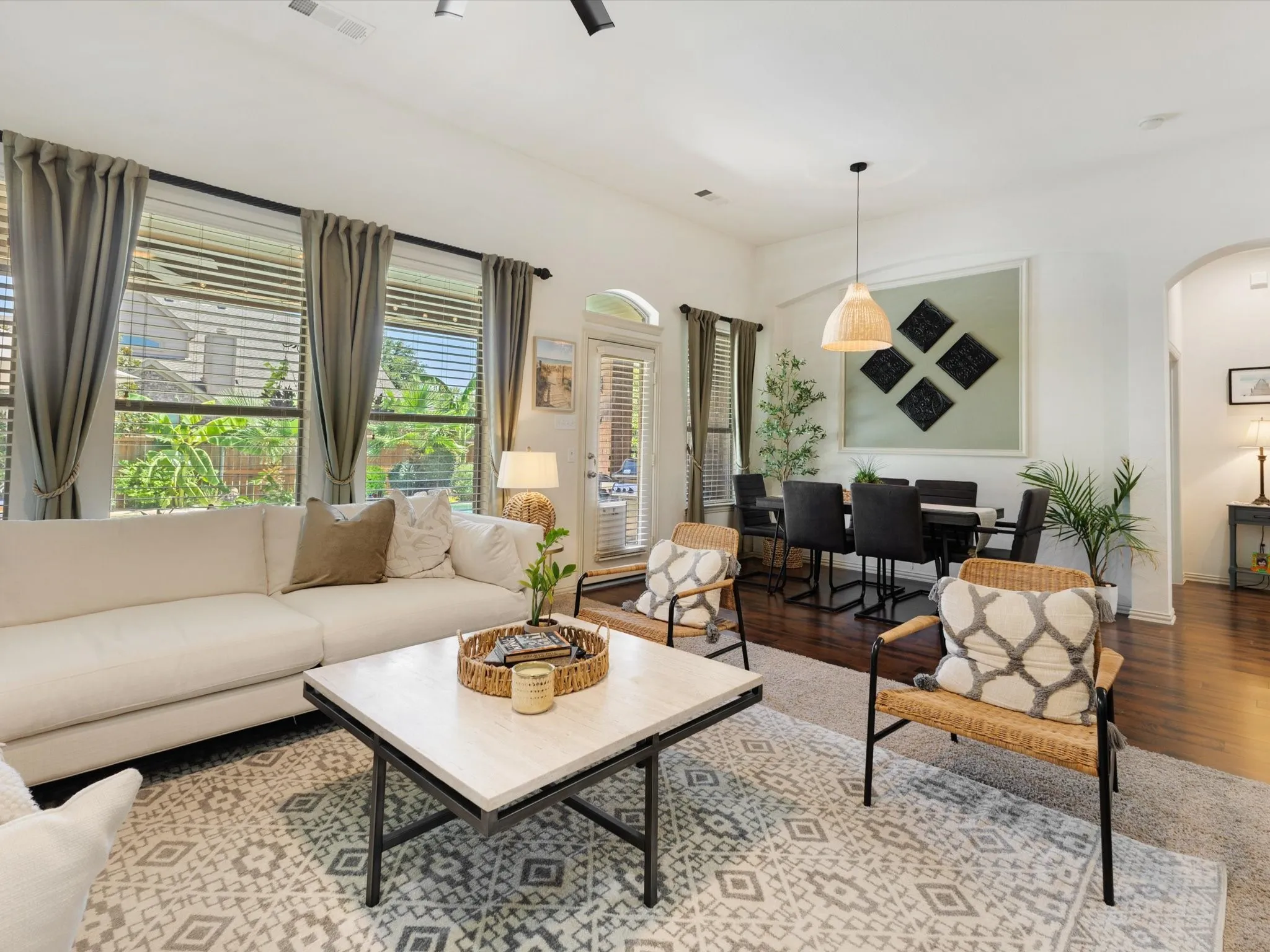 High ceilings and dark wood-finish flooring complement the natural light