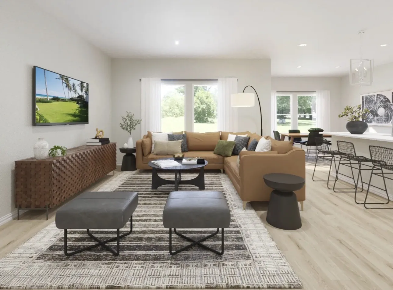 Open-concept living area featuring light wood-finish flooring, recessed lighting, and large windows