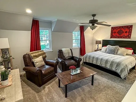 Carpeted room featuring a ceiling fan with integrated lighting, recessed lighting, and white-framed windows