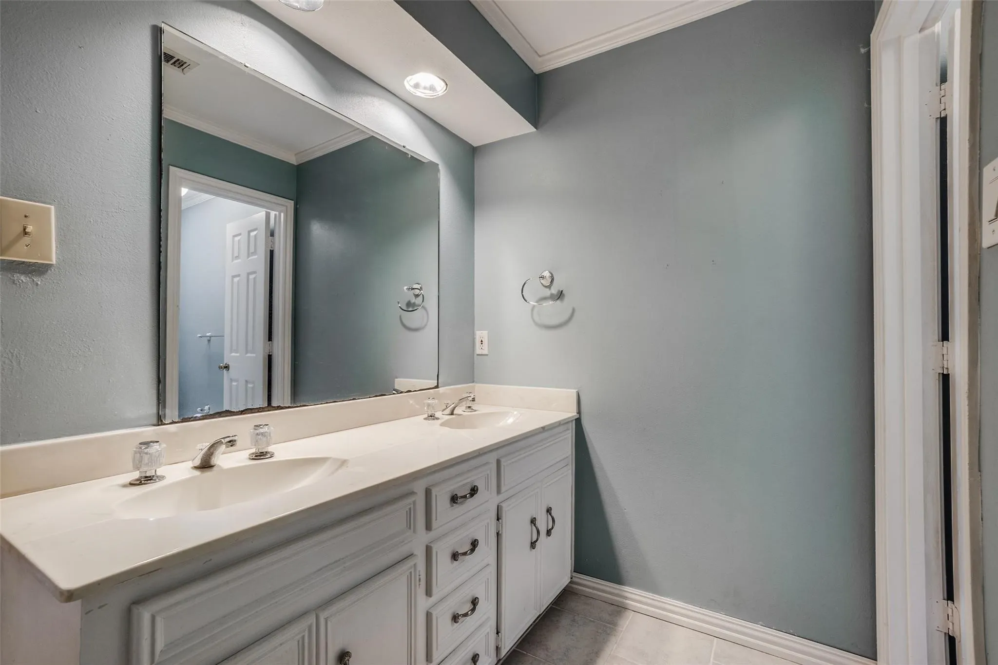 Dual vanity with integrated sinks, brushed nickel faucets, and under-counter storage