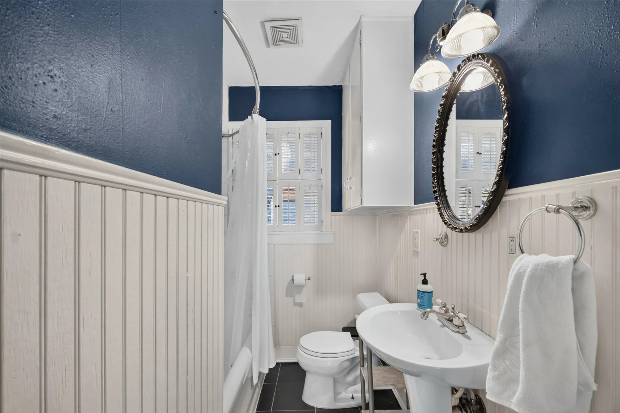White beadboard wainscoting and deep blue walls