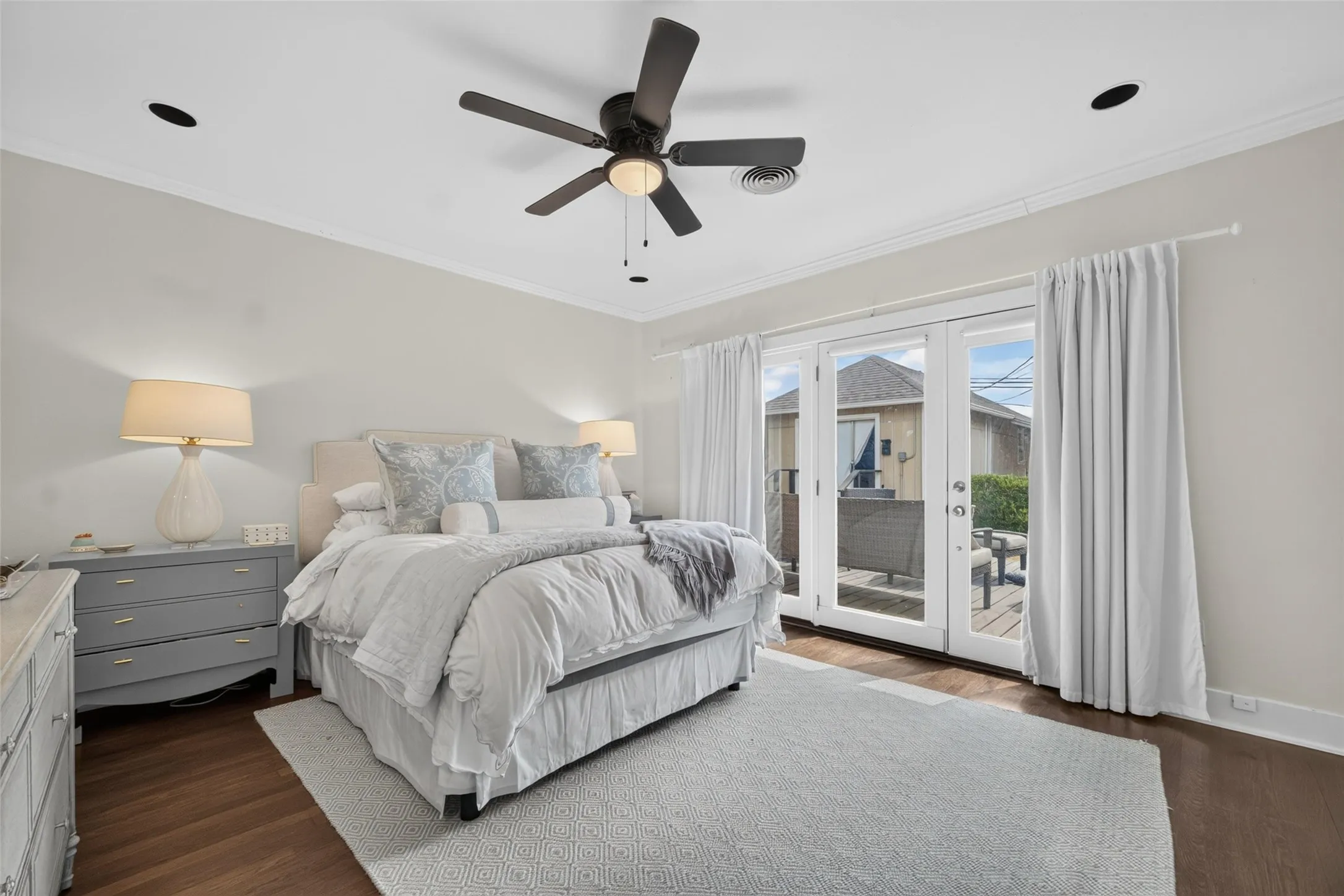Recessed lighting, crown molding, ceiling fan, wood-finish flooring, and French doors leading to an outdoor space