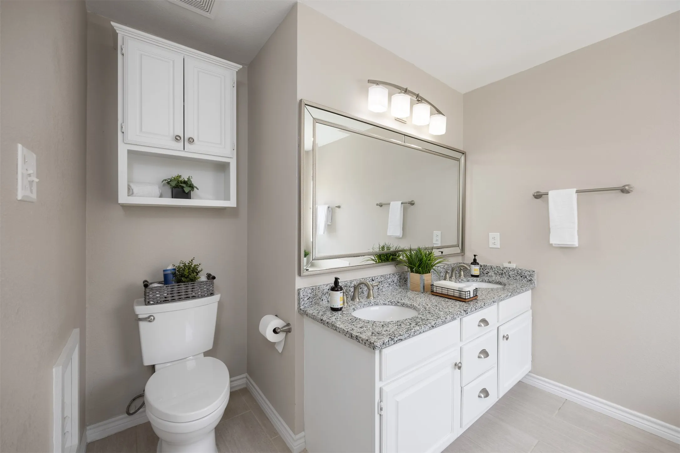 Primary ensuite bath with dual vanities, renovated separate shower, and garden tub.