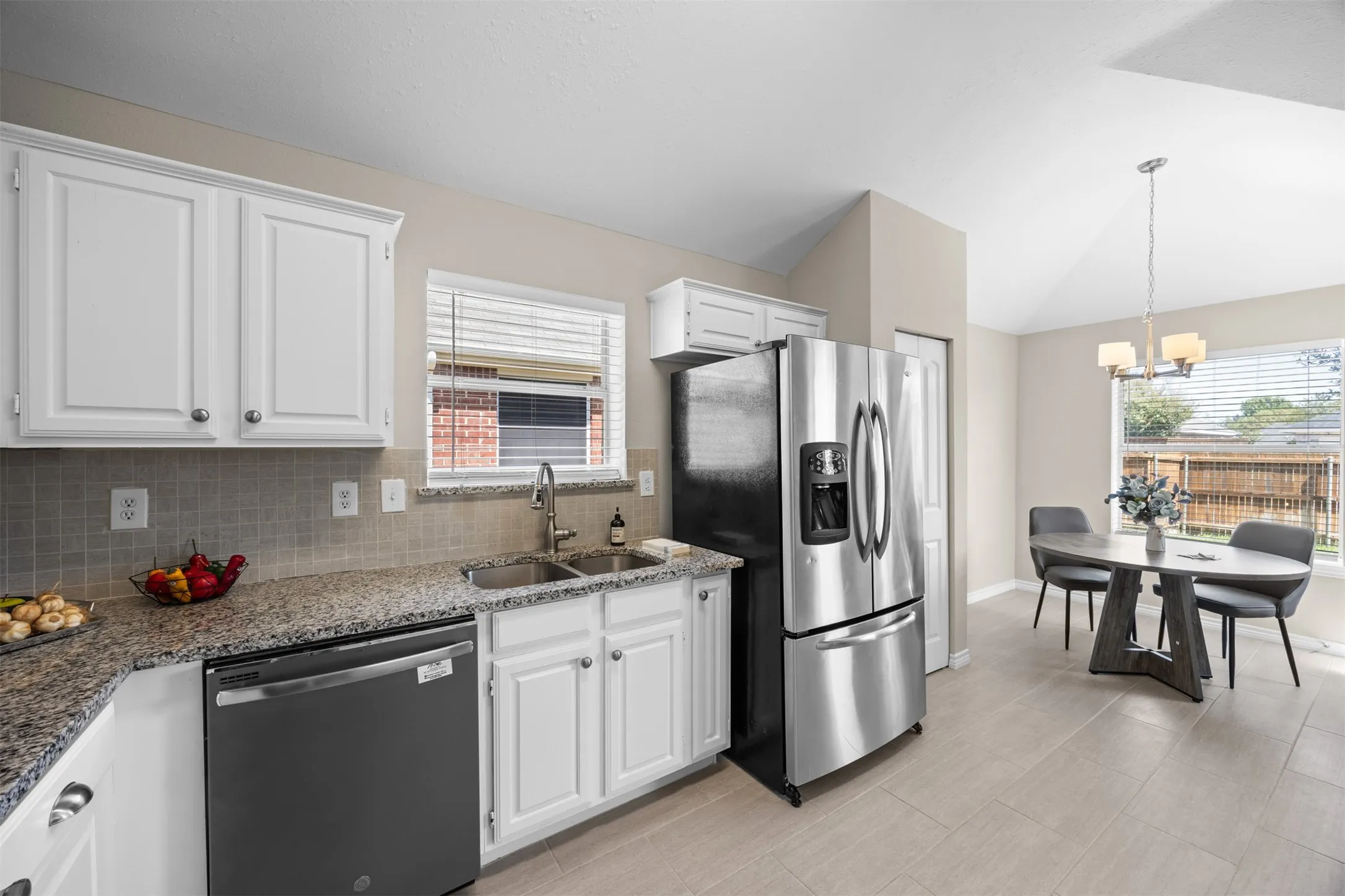 Updated kitchen with granite countertops and modern conveniences