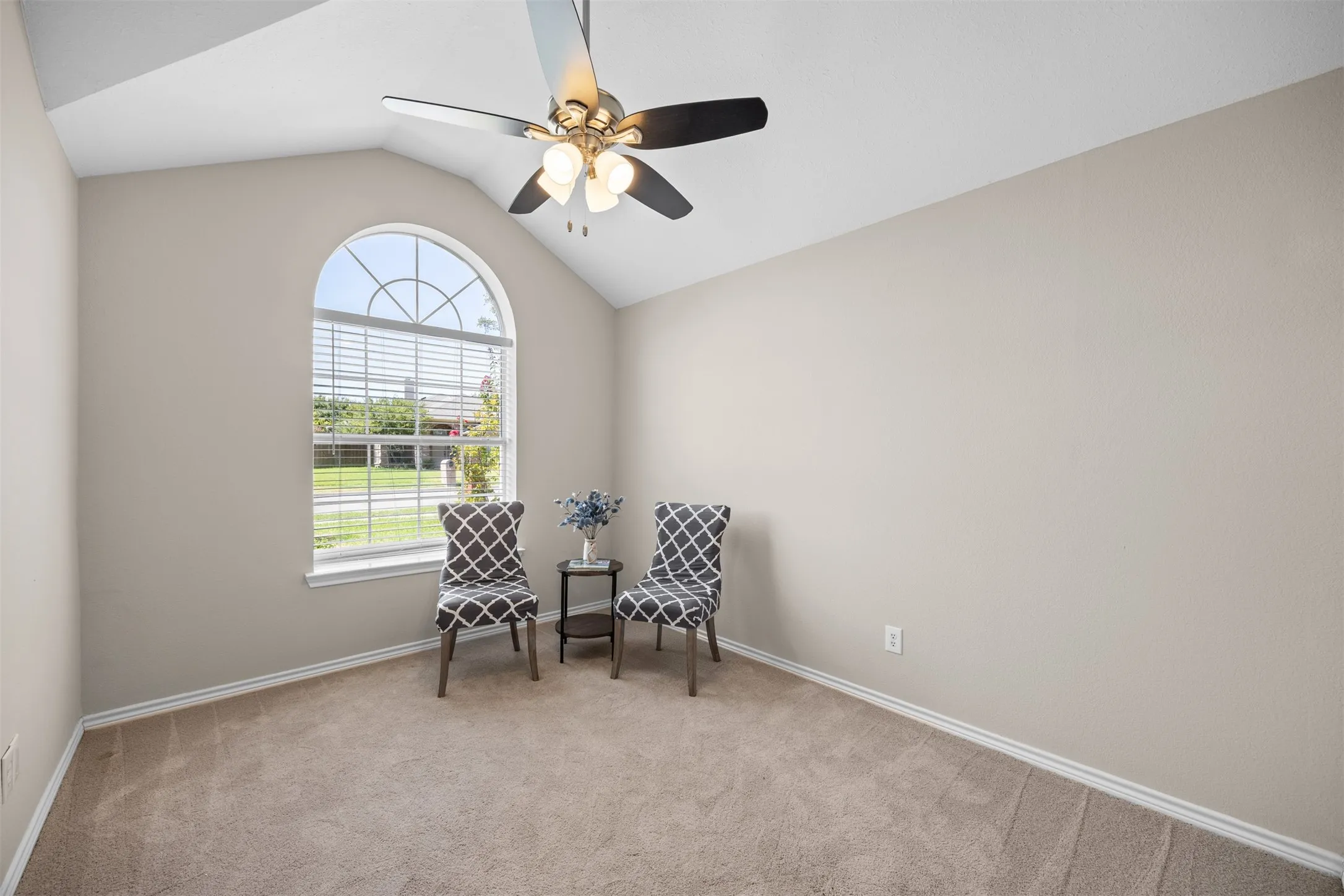 Versatile secondary bedroom with neutral finishes.