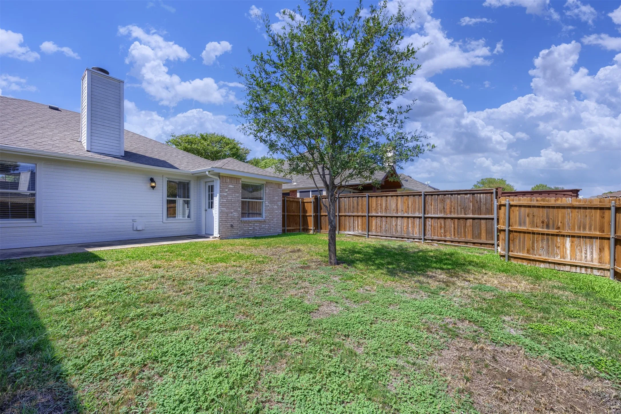 Private fenced backyard with room for outdoor relaxation.