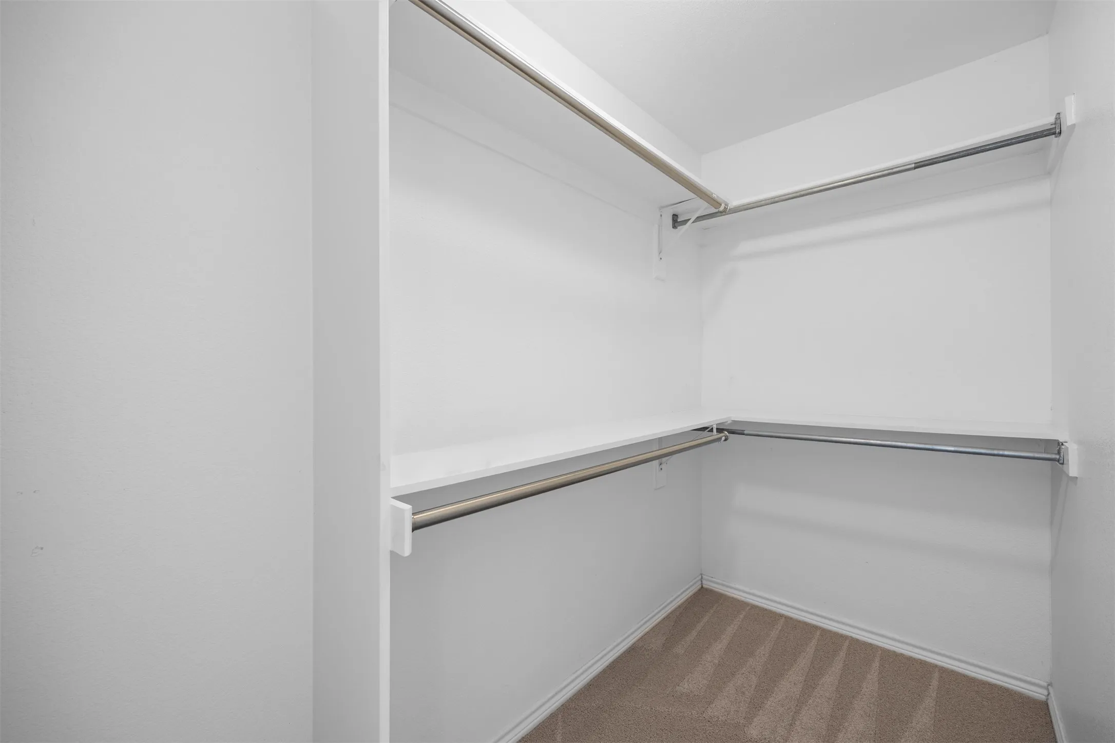 Spacious primary walk-in closet.