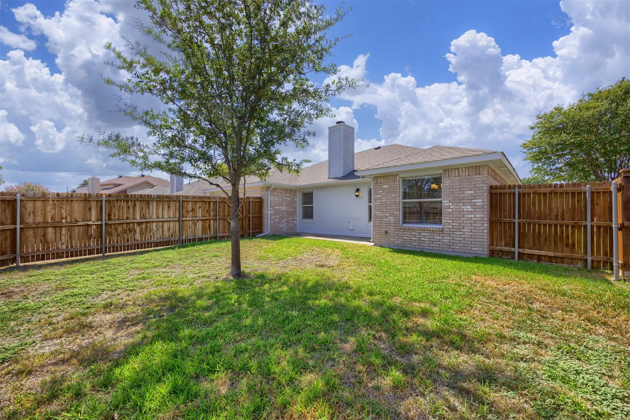 Private fenced backyard with room for outdoor relaxation.