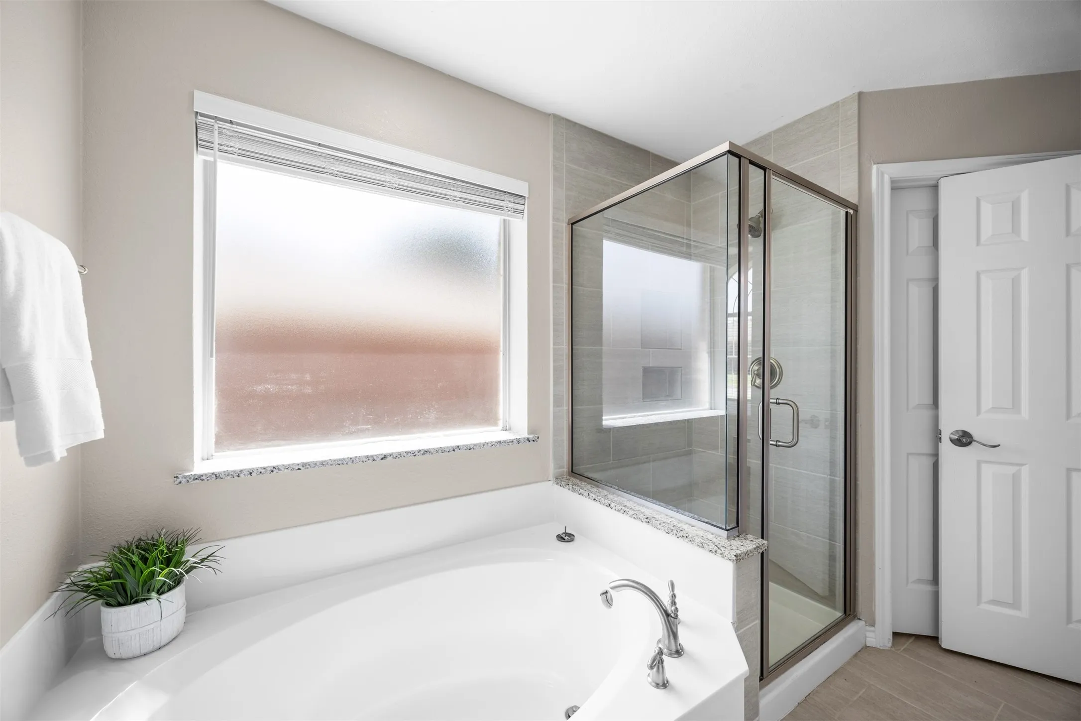 Primary ensuite bath with dual vanities, renovated separate shower, and garden tub.
