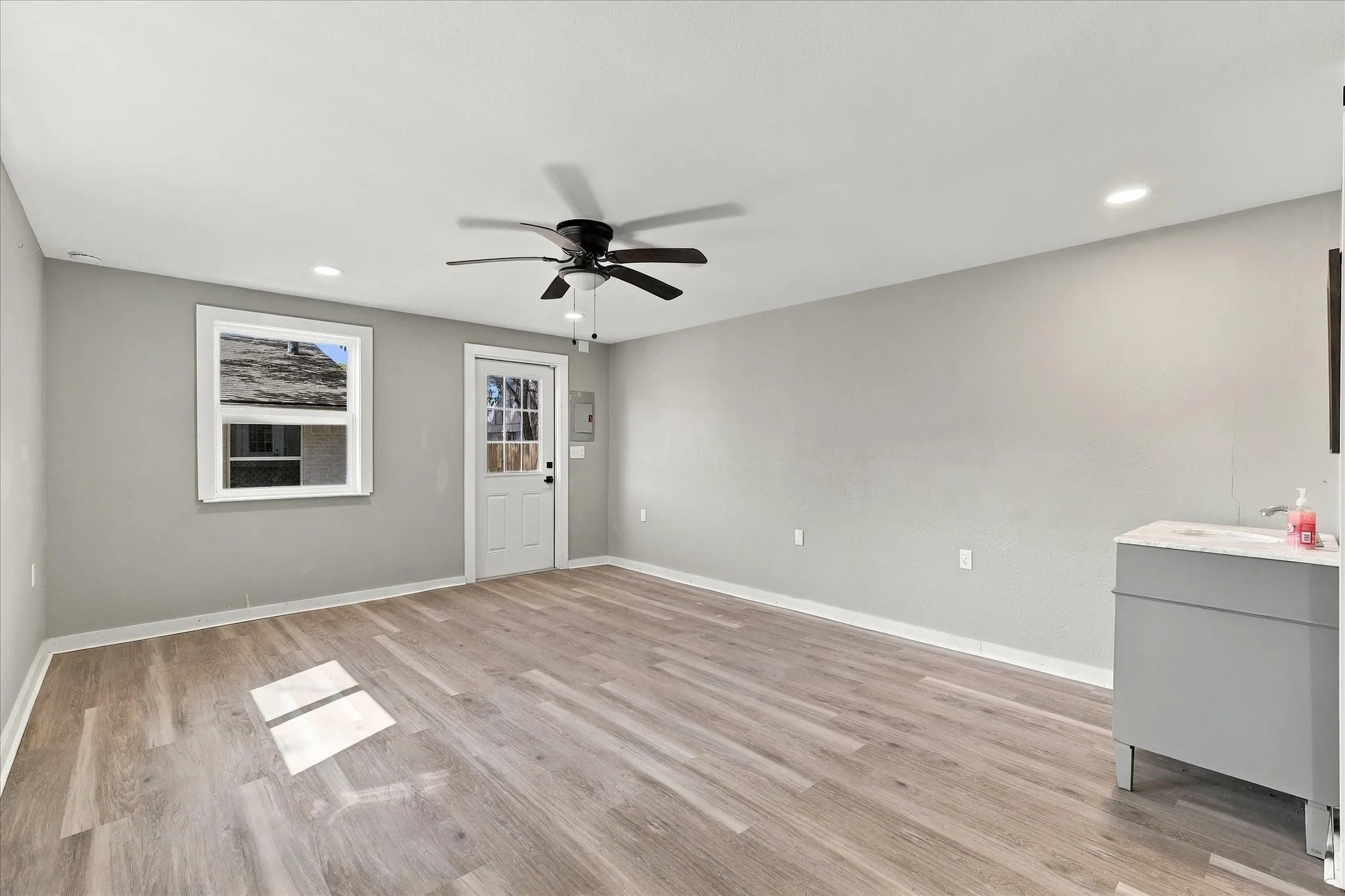 Guest unit features ceiling fan, luxury vinyl plank floors and updated windows.