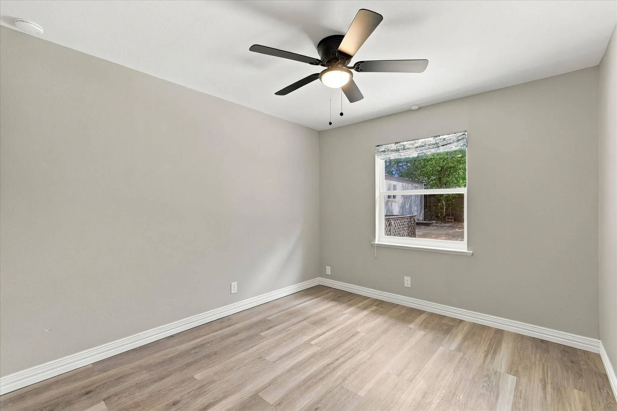 Sunny bedroom with ceiling fan
