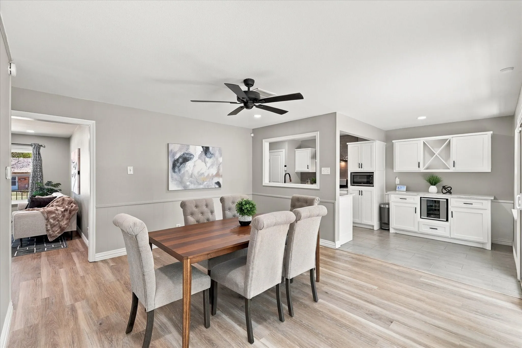Dining area with ceiling fan connects the home