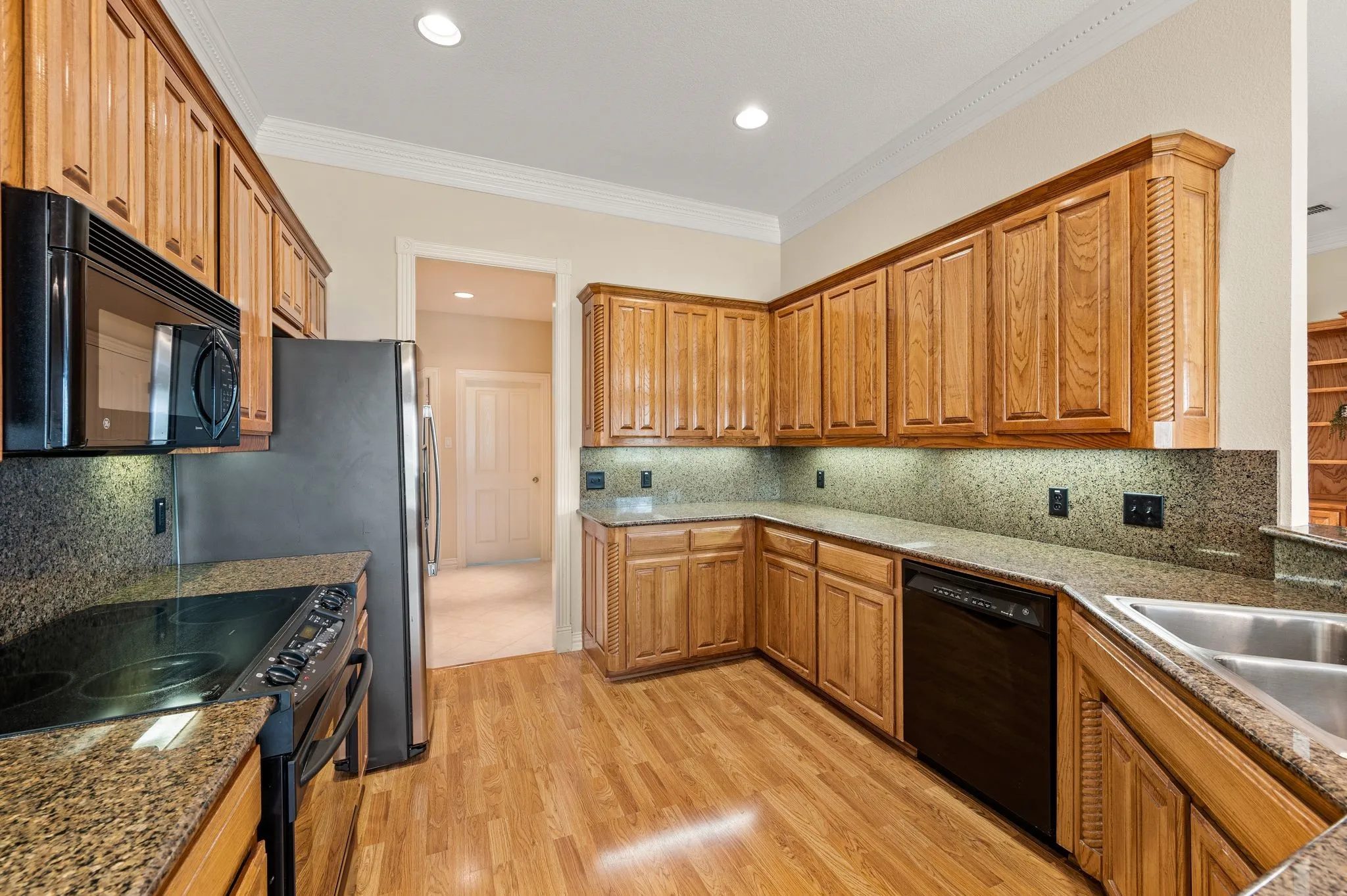 Large kitchen with view into hall leading to mudroom area