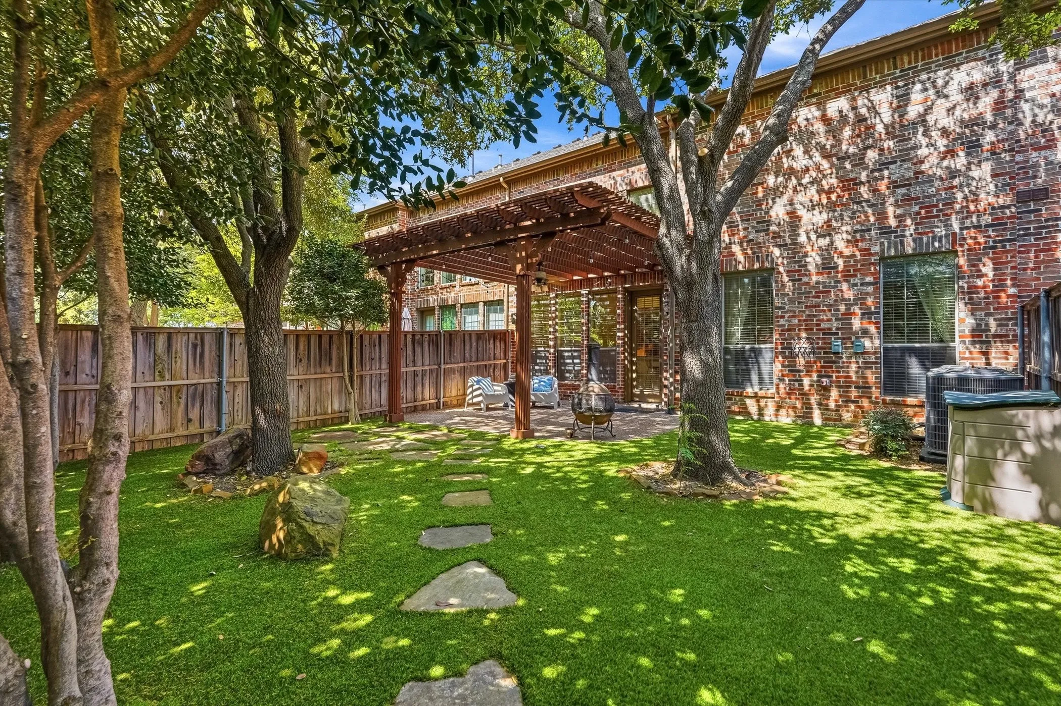 Fenced backyard featuring a patio area and a pergola