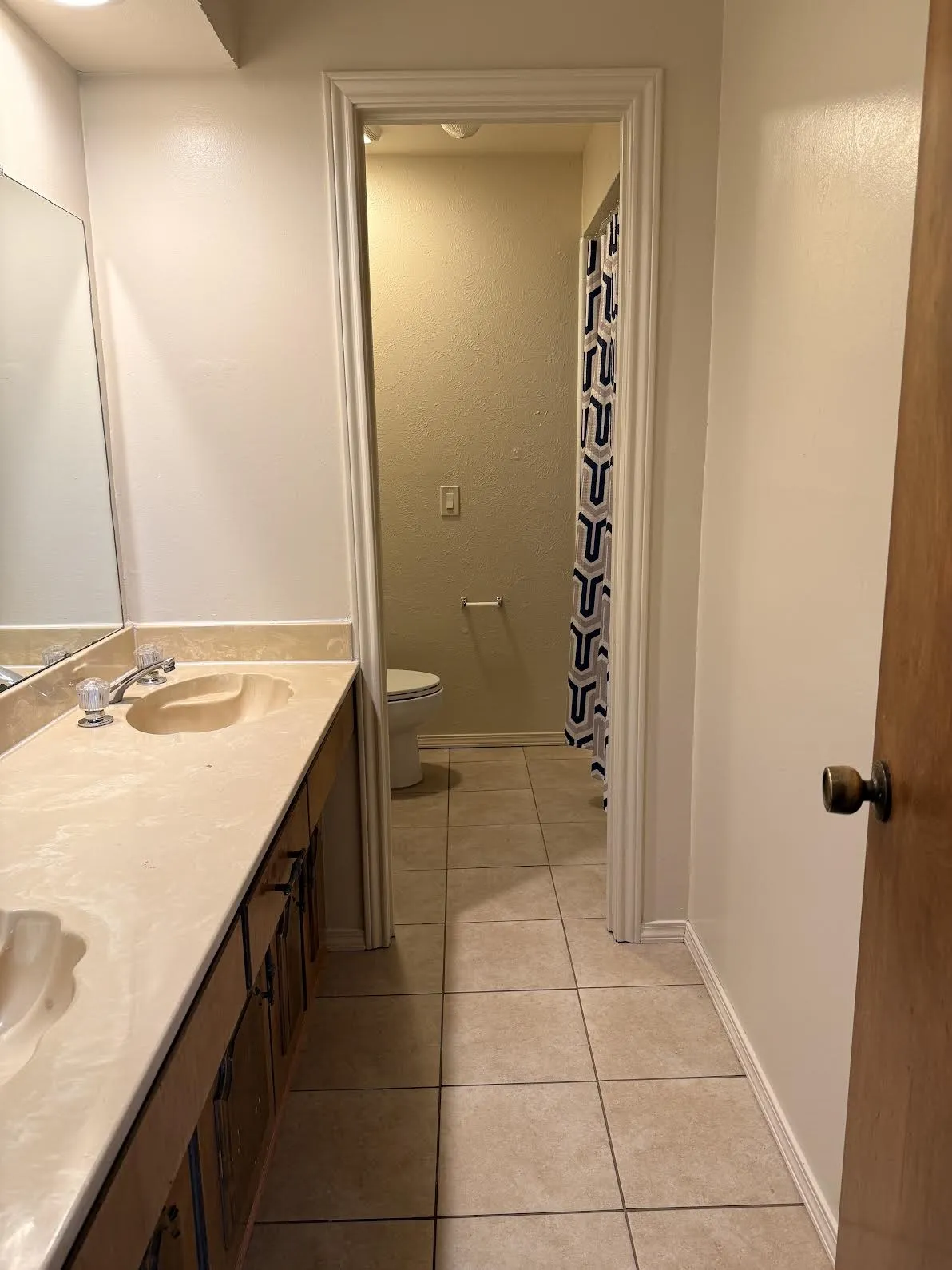 Secondary bathroom with double vanity and separate shower area.
