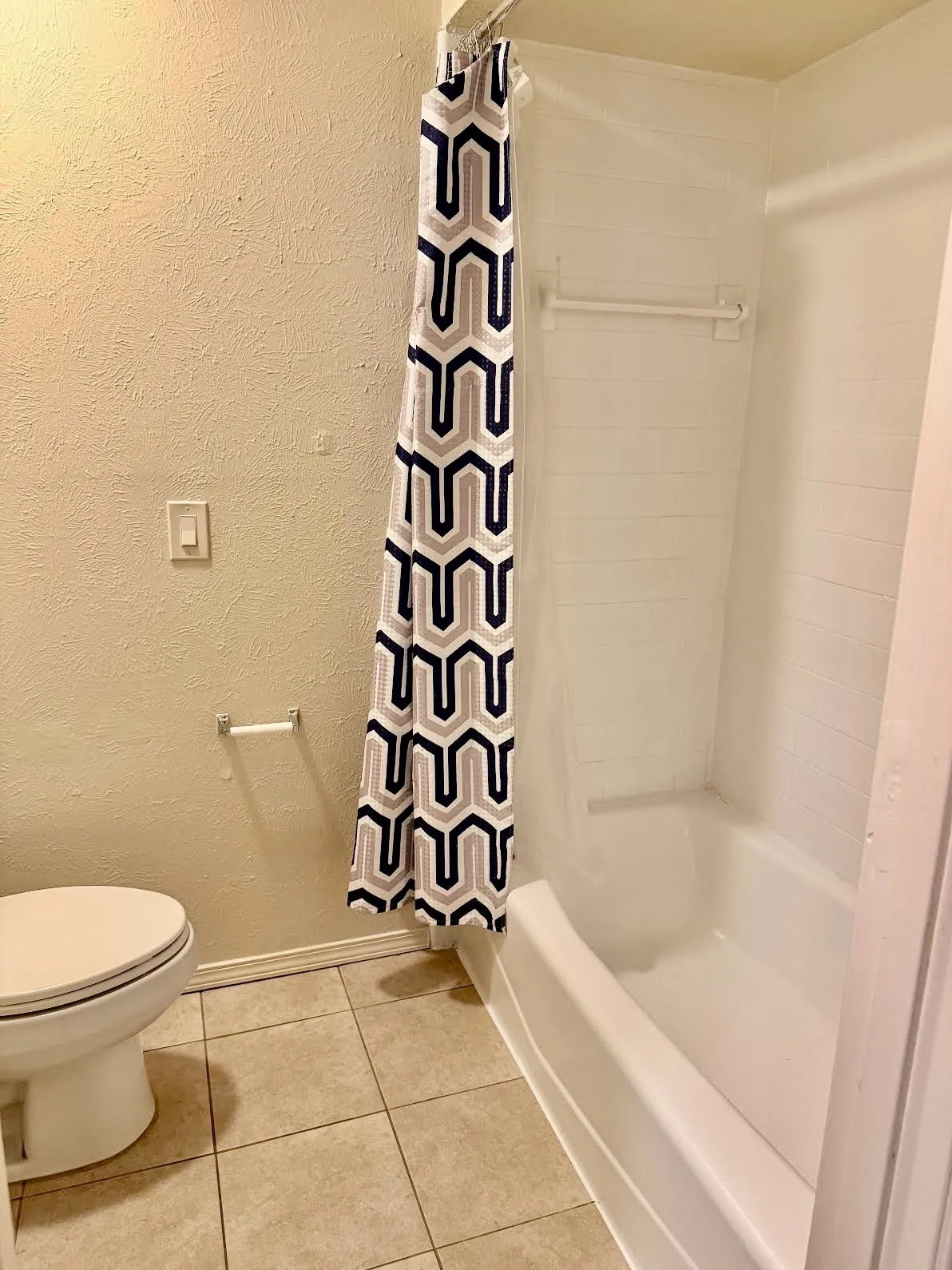 Secondary bathroom with separate shower area.