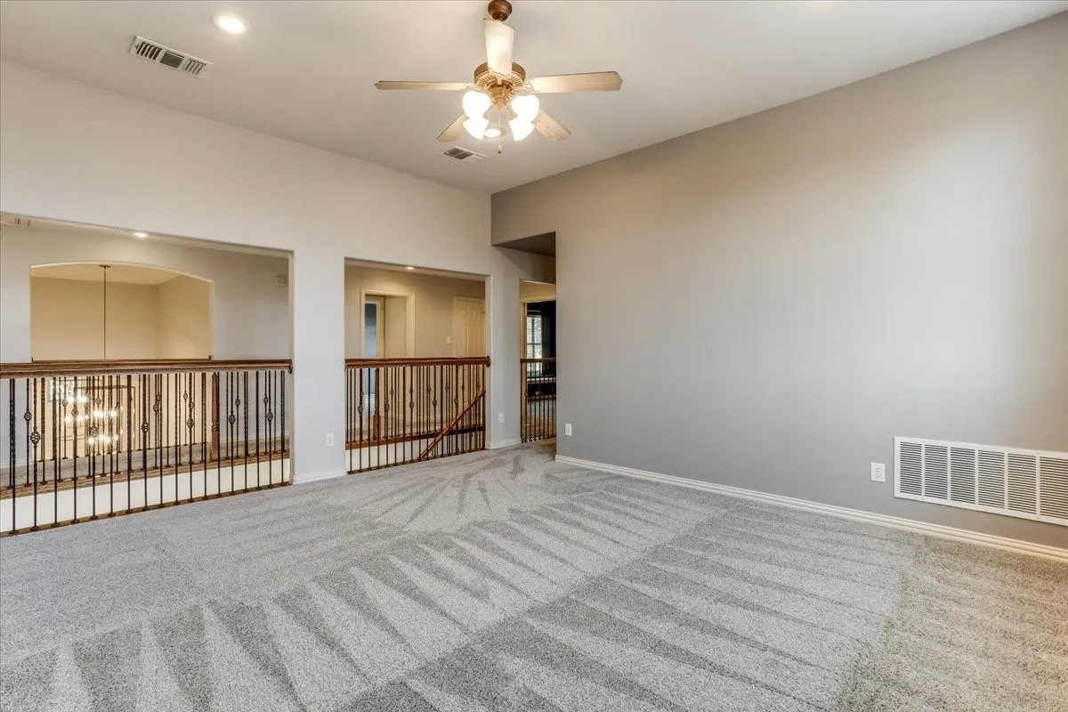 Spacious room featuring carpeting, recessed lighting, and a ceiling fan