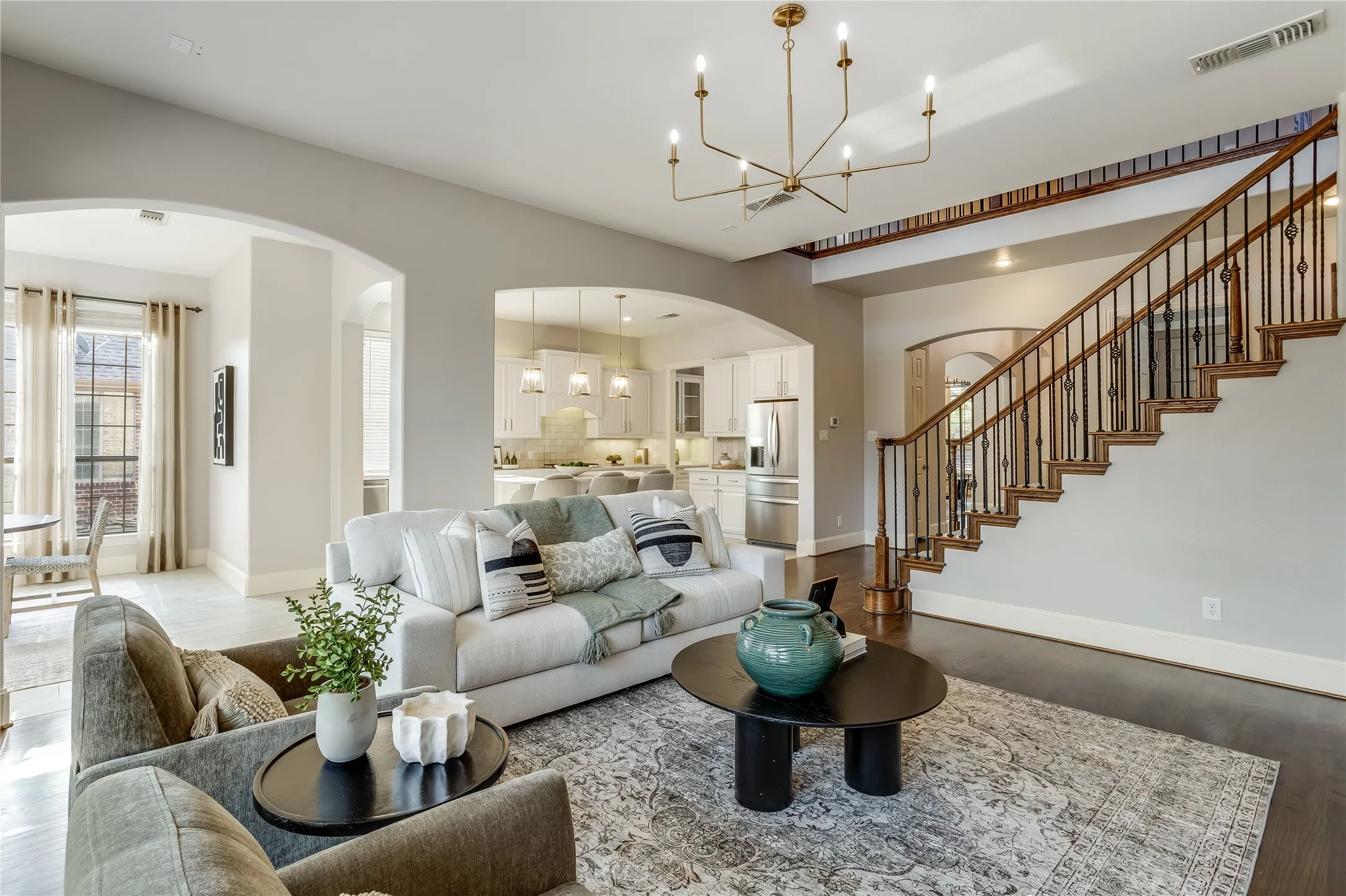Open-concept living area featuring a vaulted ceiling and dark wood-finish flooring