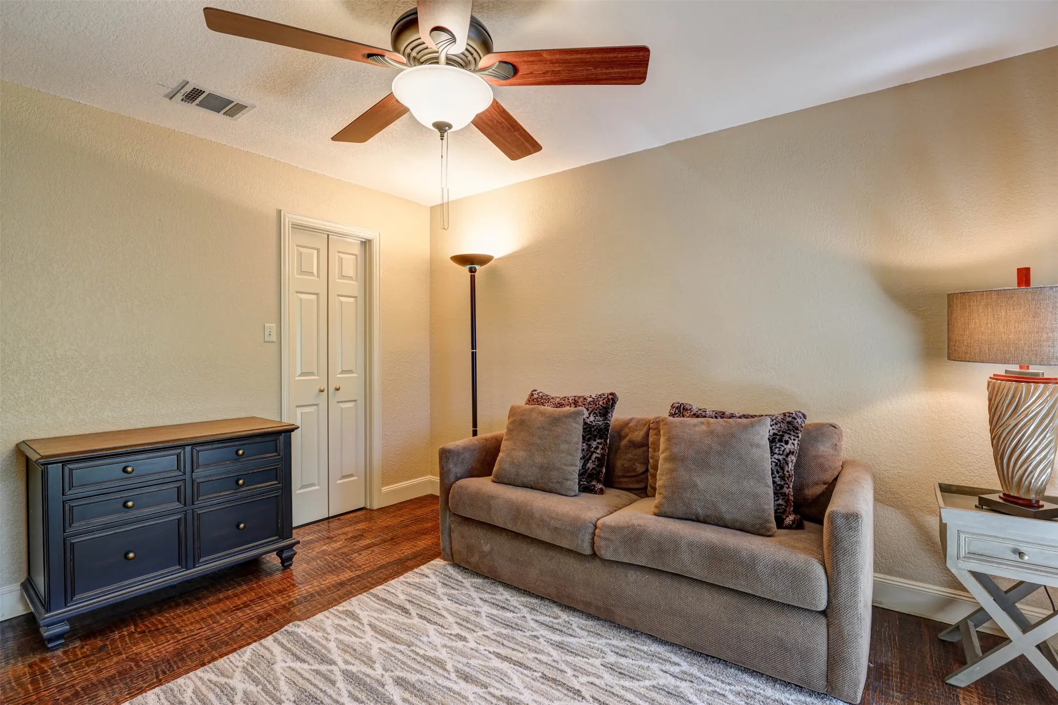 Bright secondary bedroom offering generous space and a  walk in closet.
