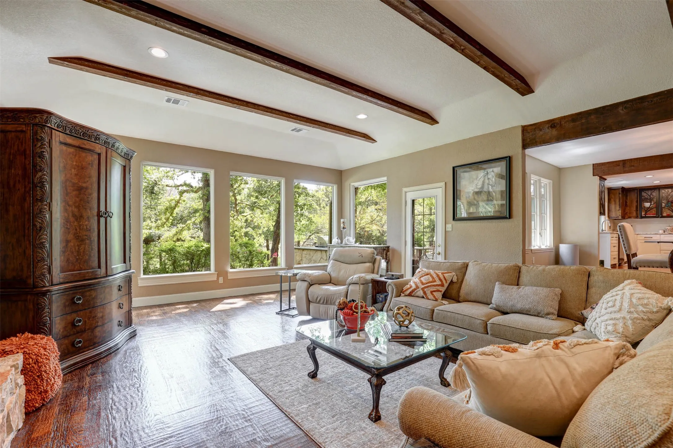 Open living space with exposed beams and seamless flow to the dining area.