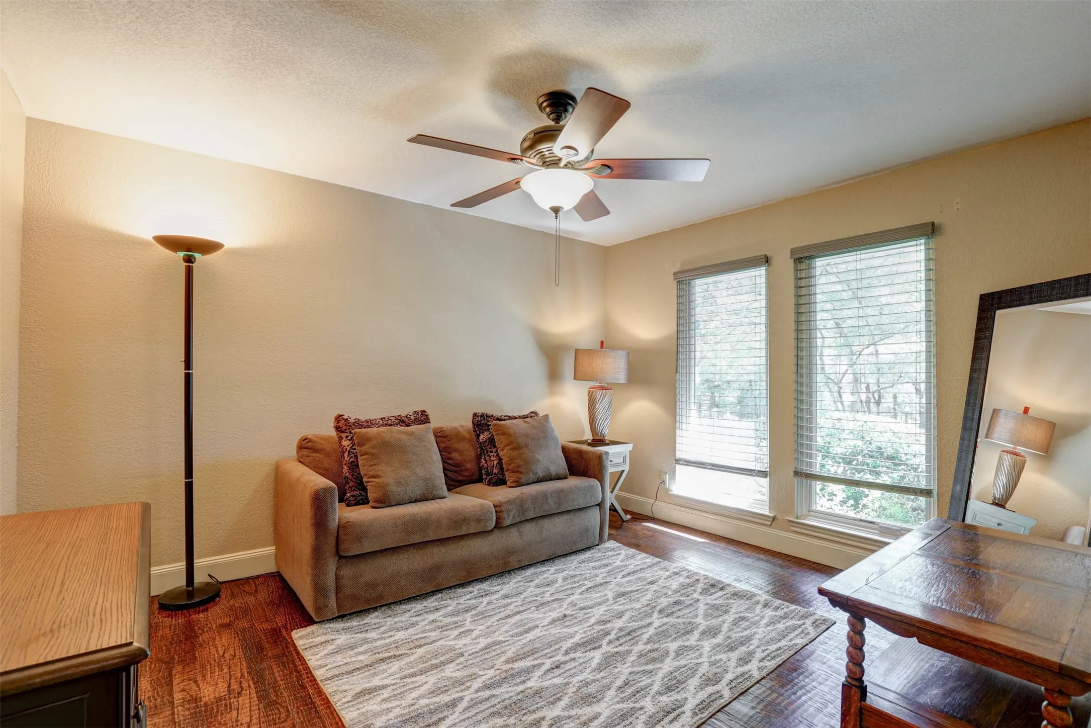 Spacious secondary bedroom with ceiling fan and walk in closet.