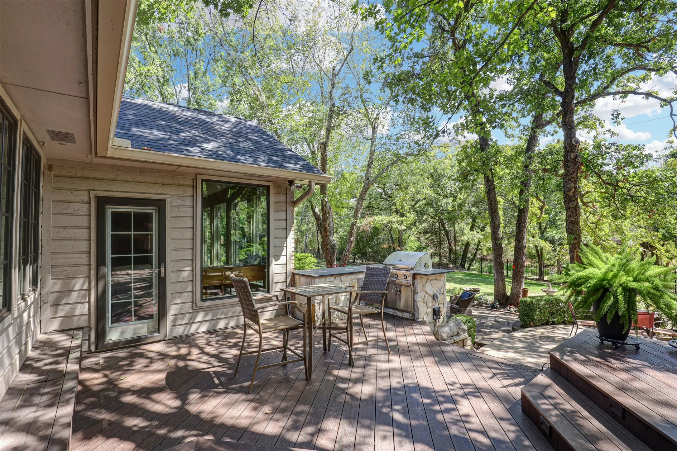 Spacious deck with built in stone grill and room for outdoor dining and entertaining.