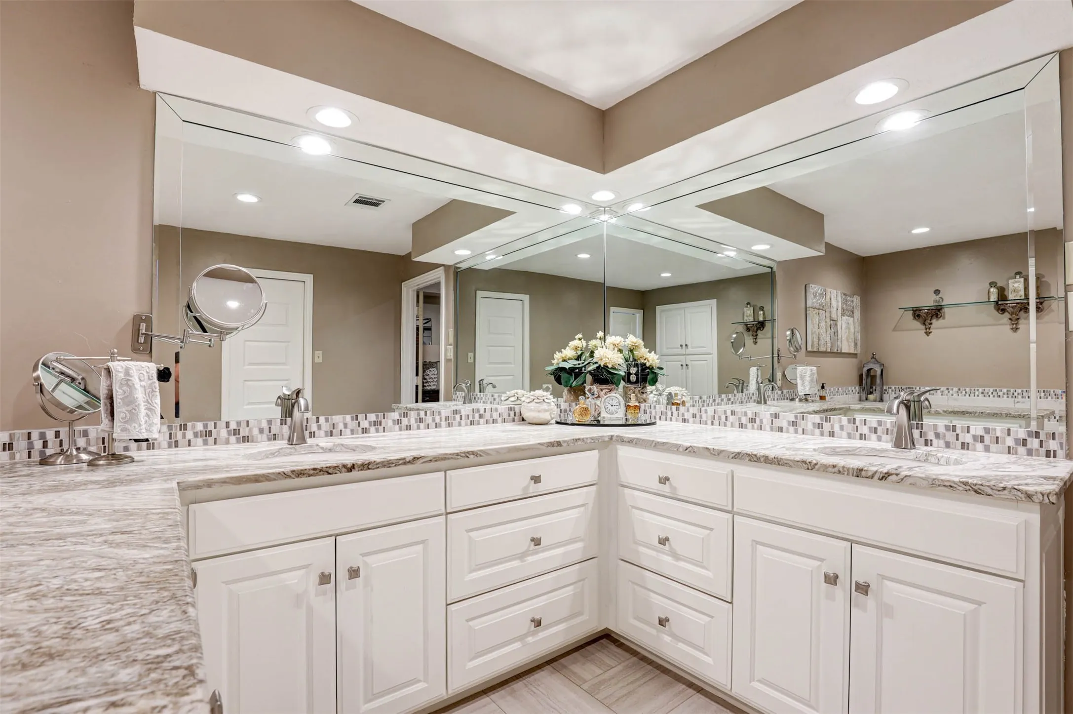 Spacious primary bath with dual-sink vanity, generous cabinetry and upgraded finishes.