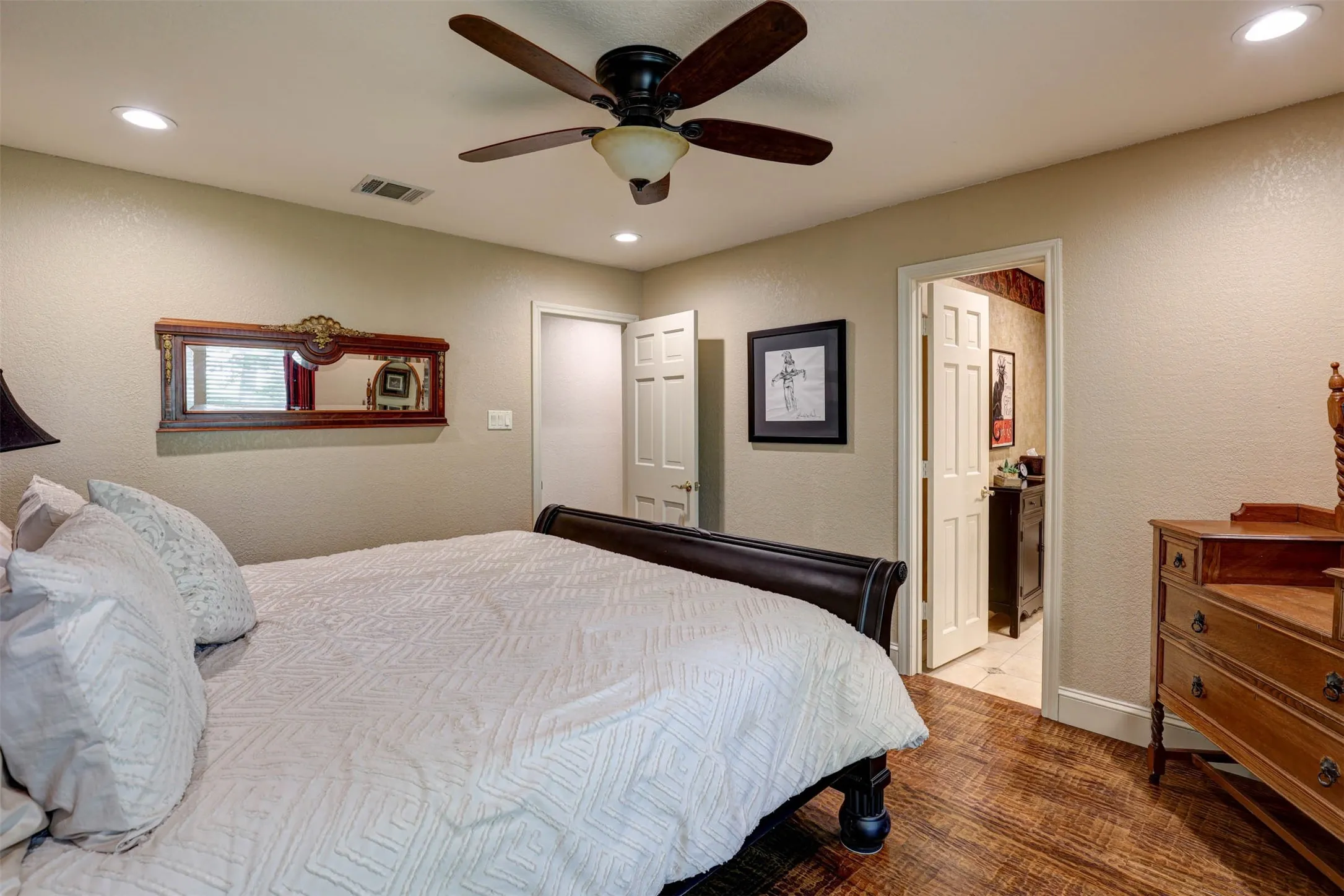 Bedroom with walk in closet and ensuite-style access to the shared bath.