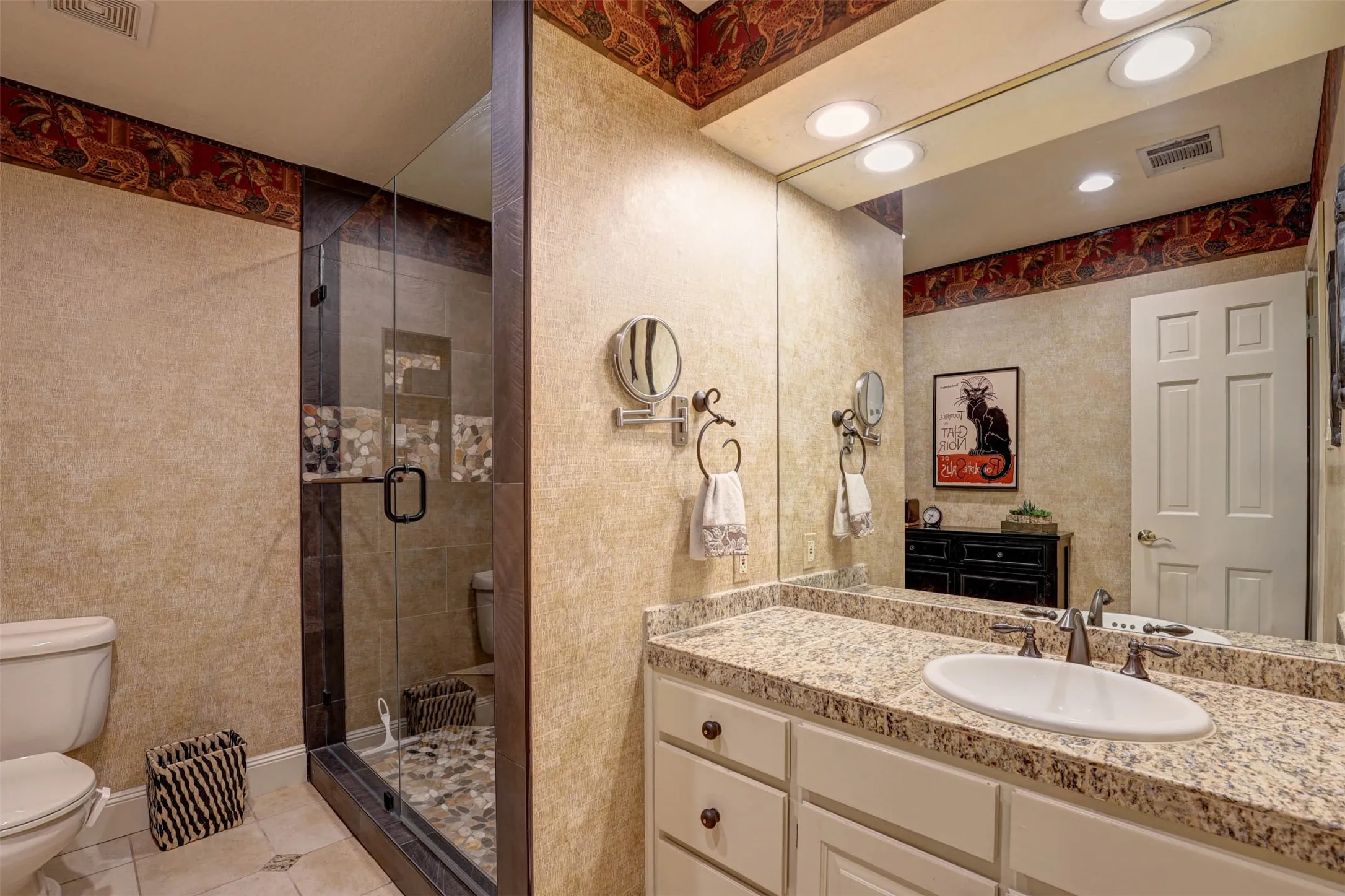 Beautifully finished shared bath with spacious vanity and designer touches.