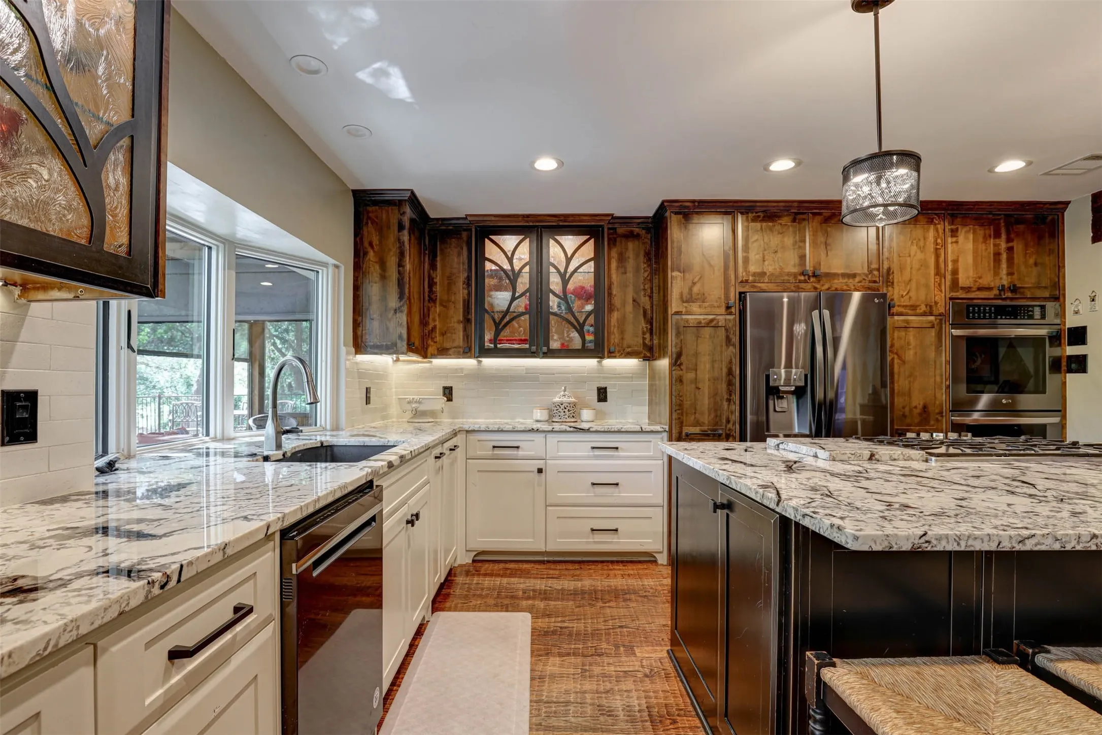 Kitchen features custom cabinetry, stainless appliances, and a spacious island for gathering.